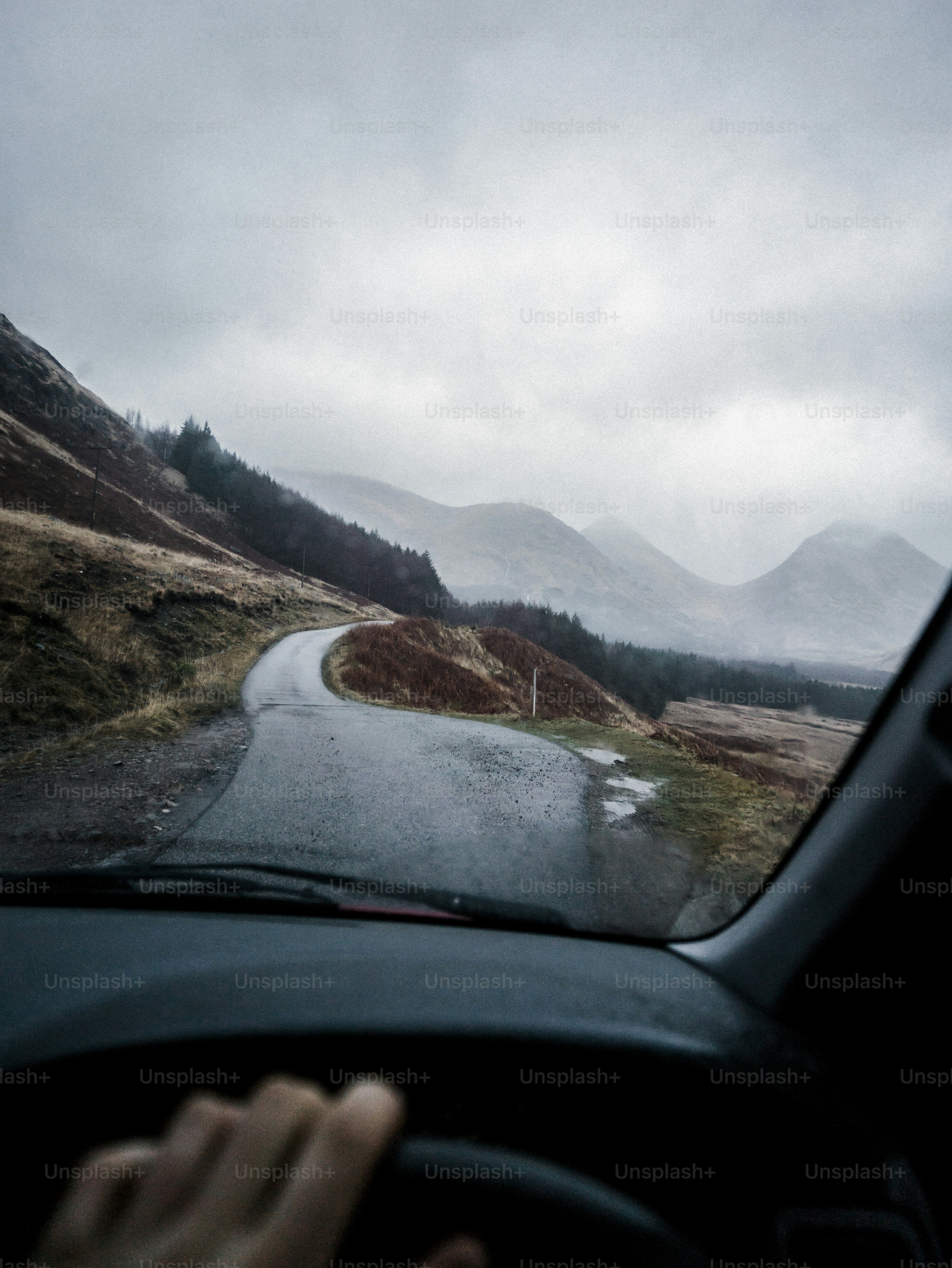 Man driving a car in the Highlands, Scotland