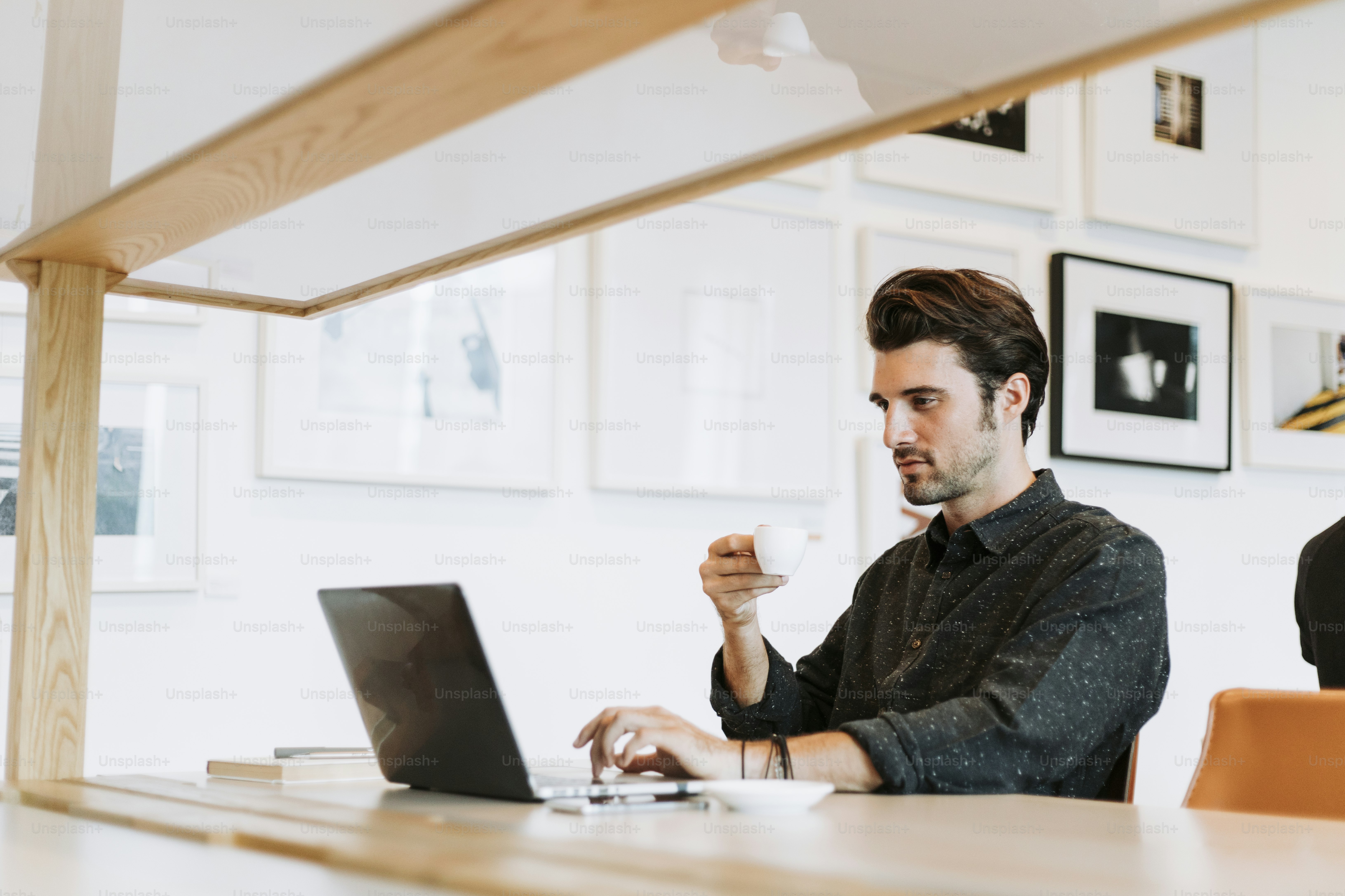 Man drinking coffee while working
