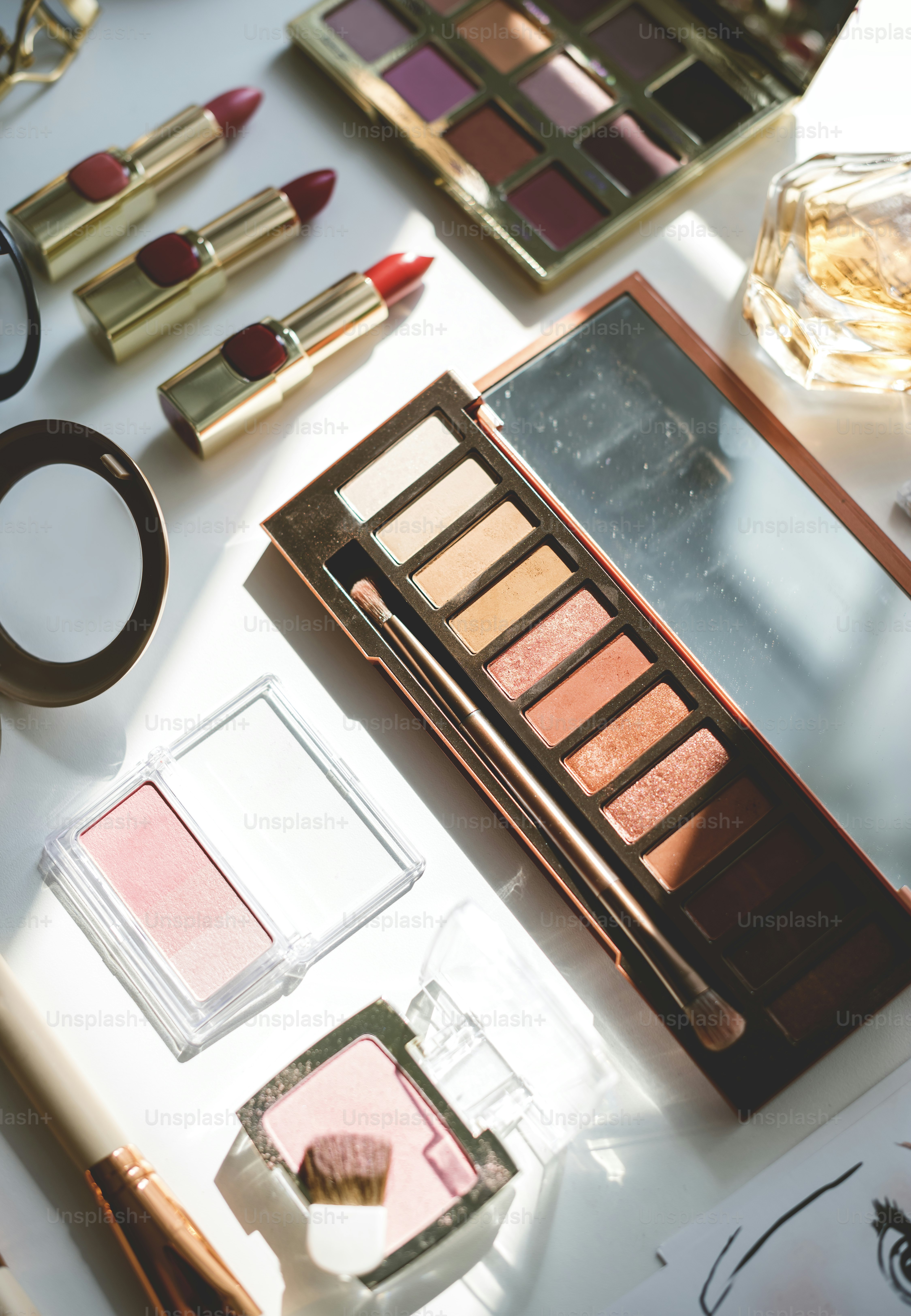 Various makeup products on white table