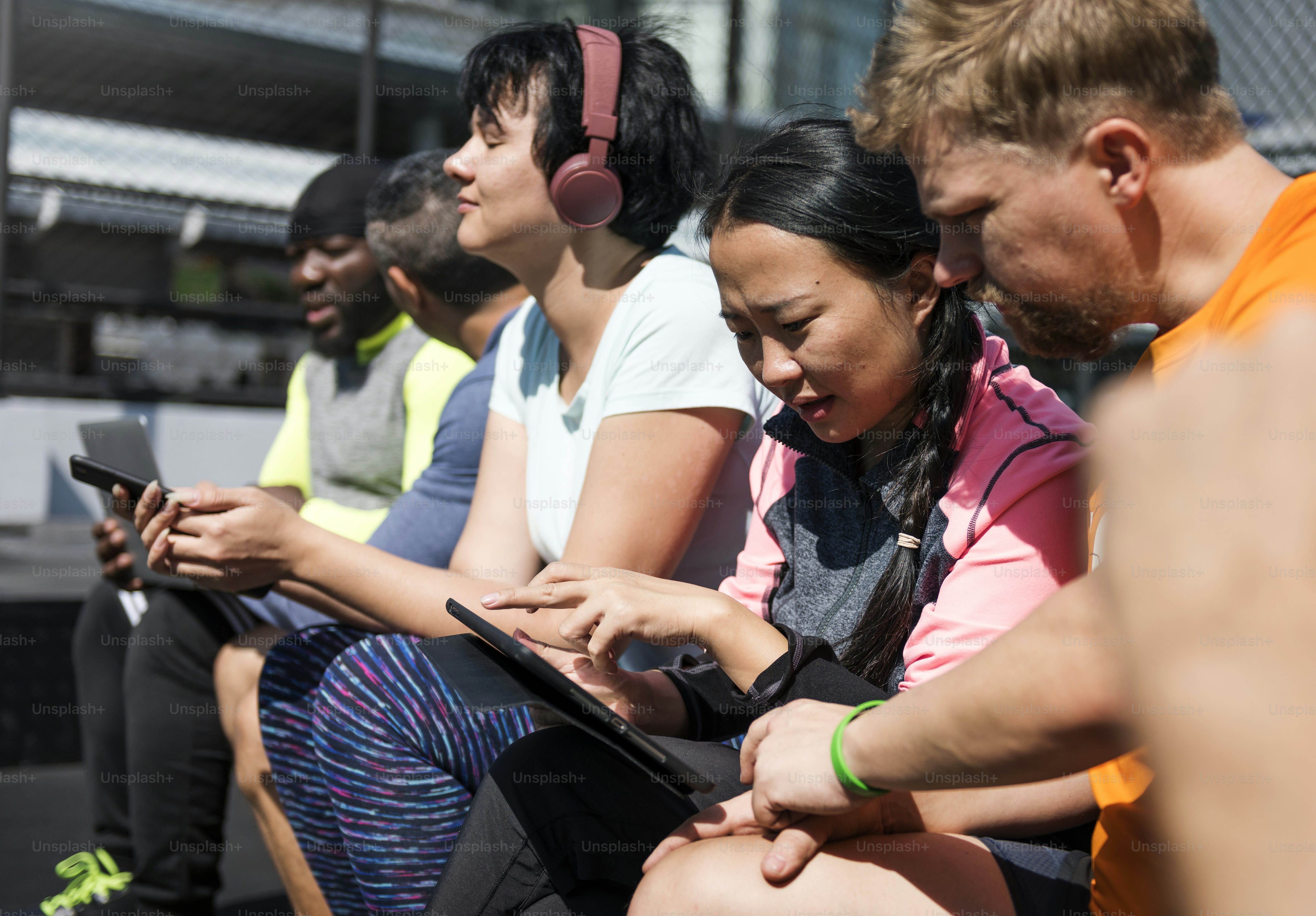 Group of diverse people using digital devices photo – Wellness Image on ...