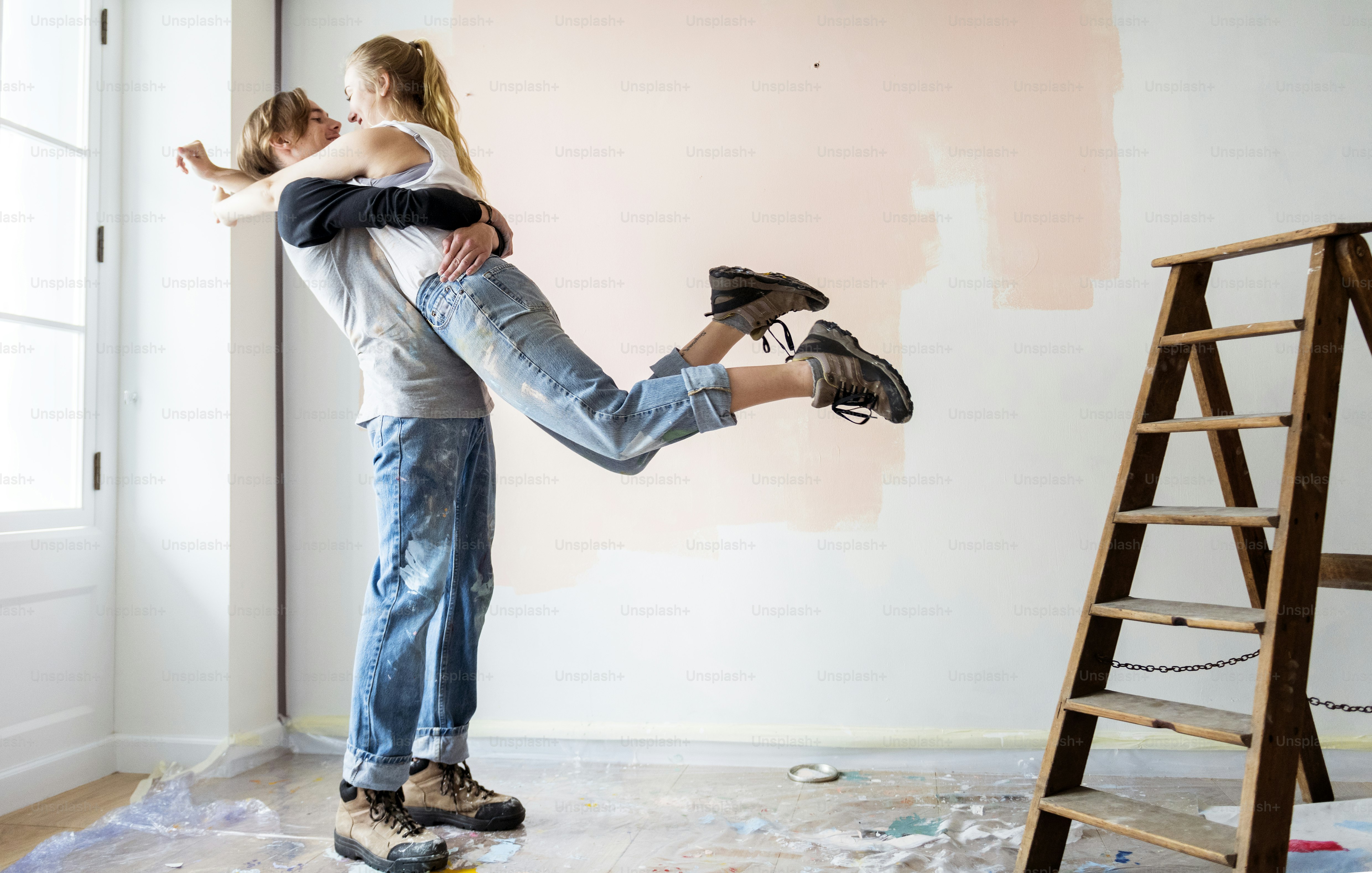 Cheerful couple renovating the house