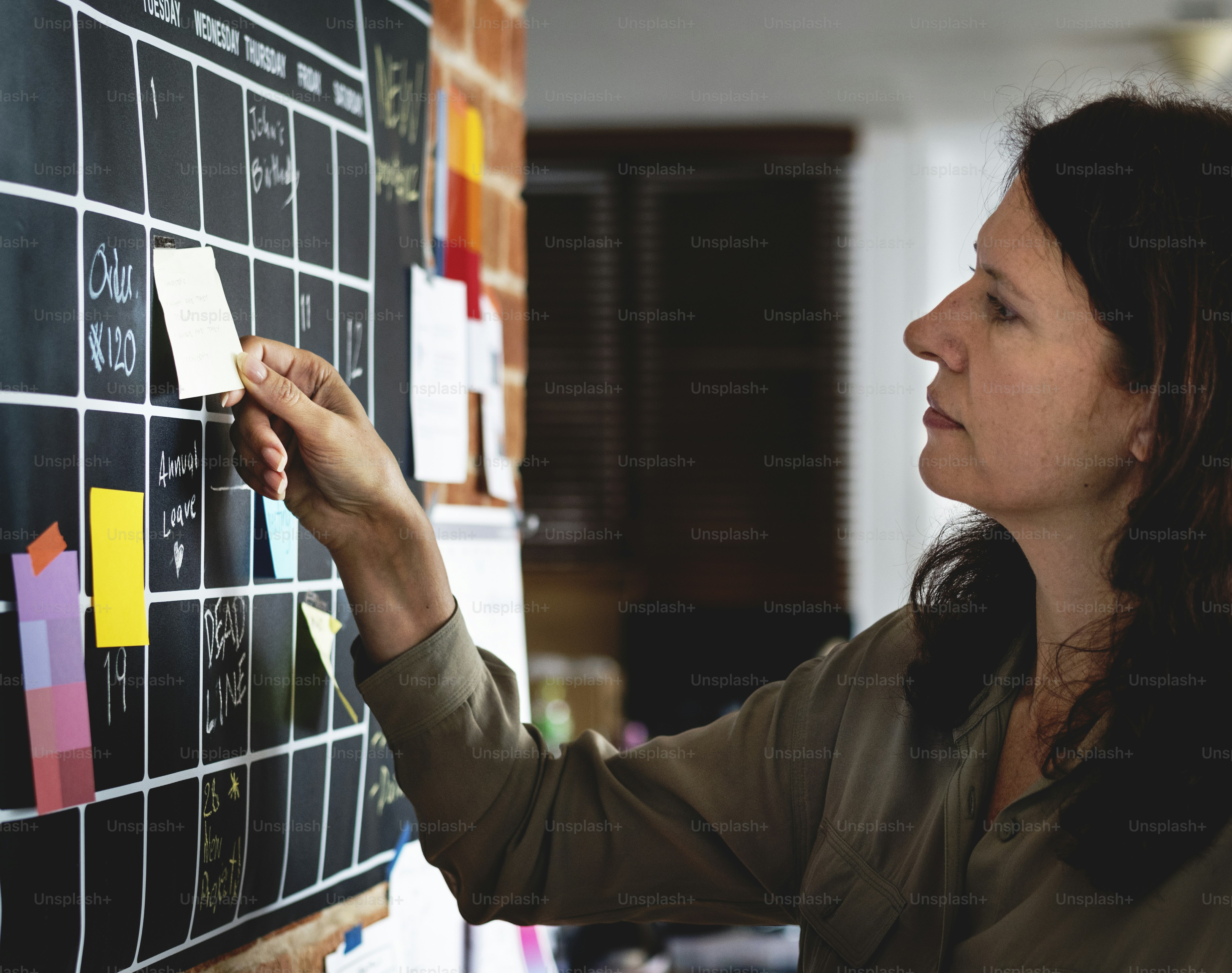 Woman pulling sticky note