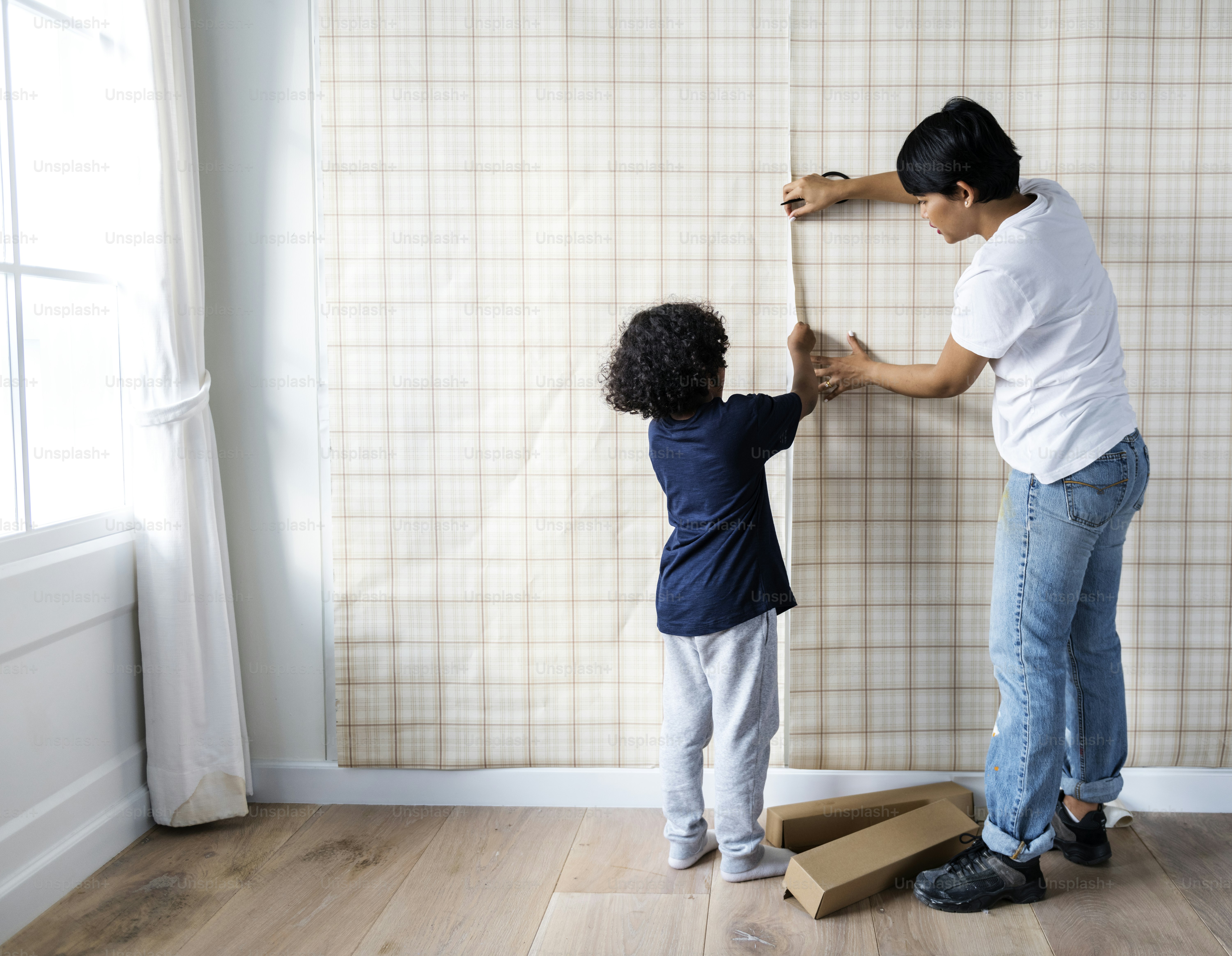 Kid helping mom install wallpaper photo – Family Image on Unsplash