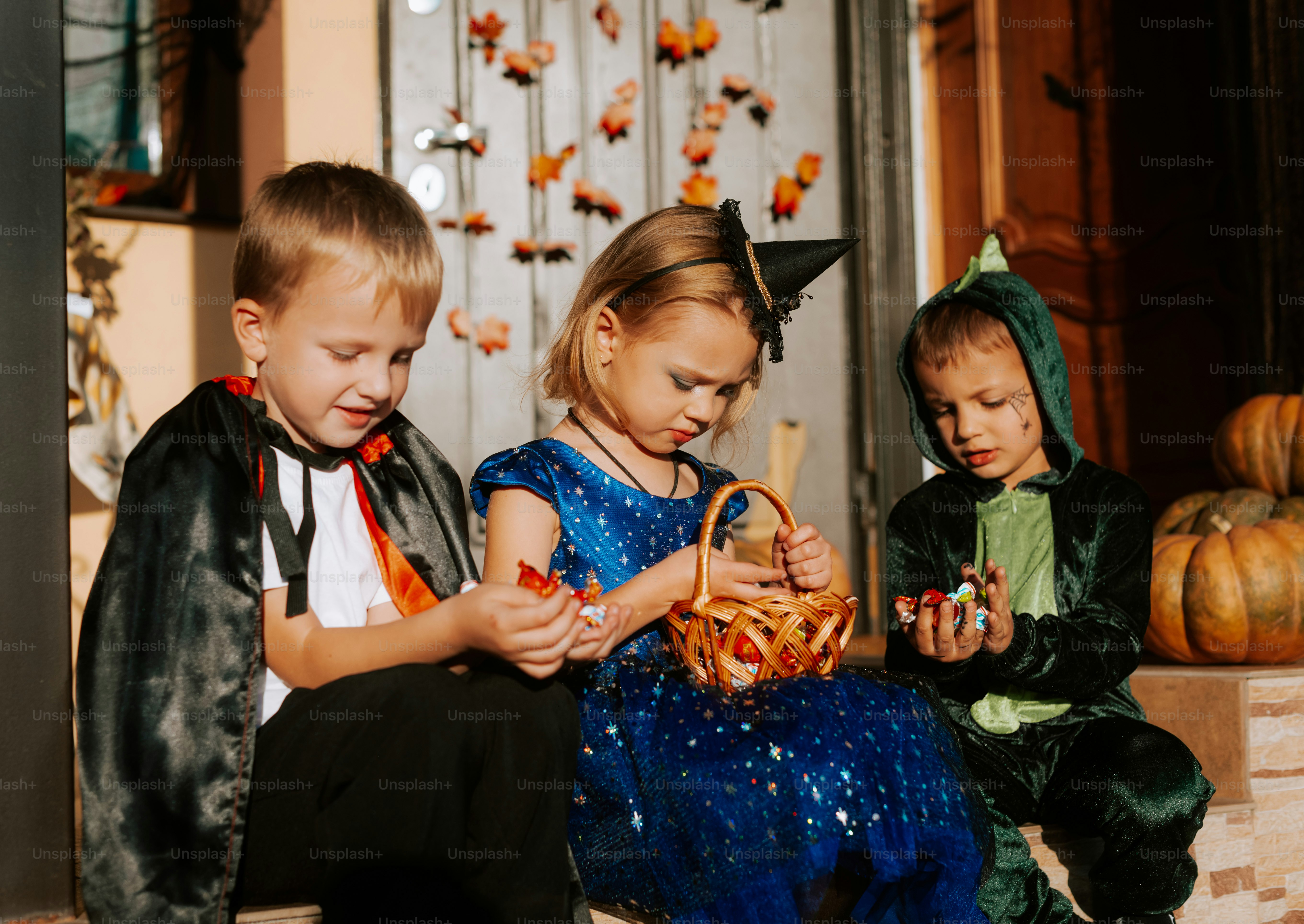 A group of children sitting on the steps of a house