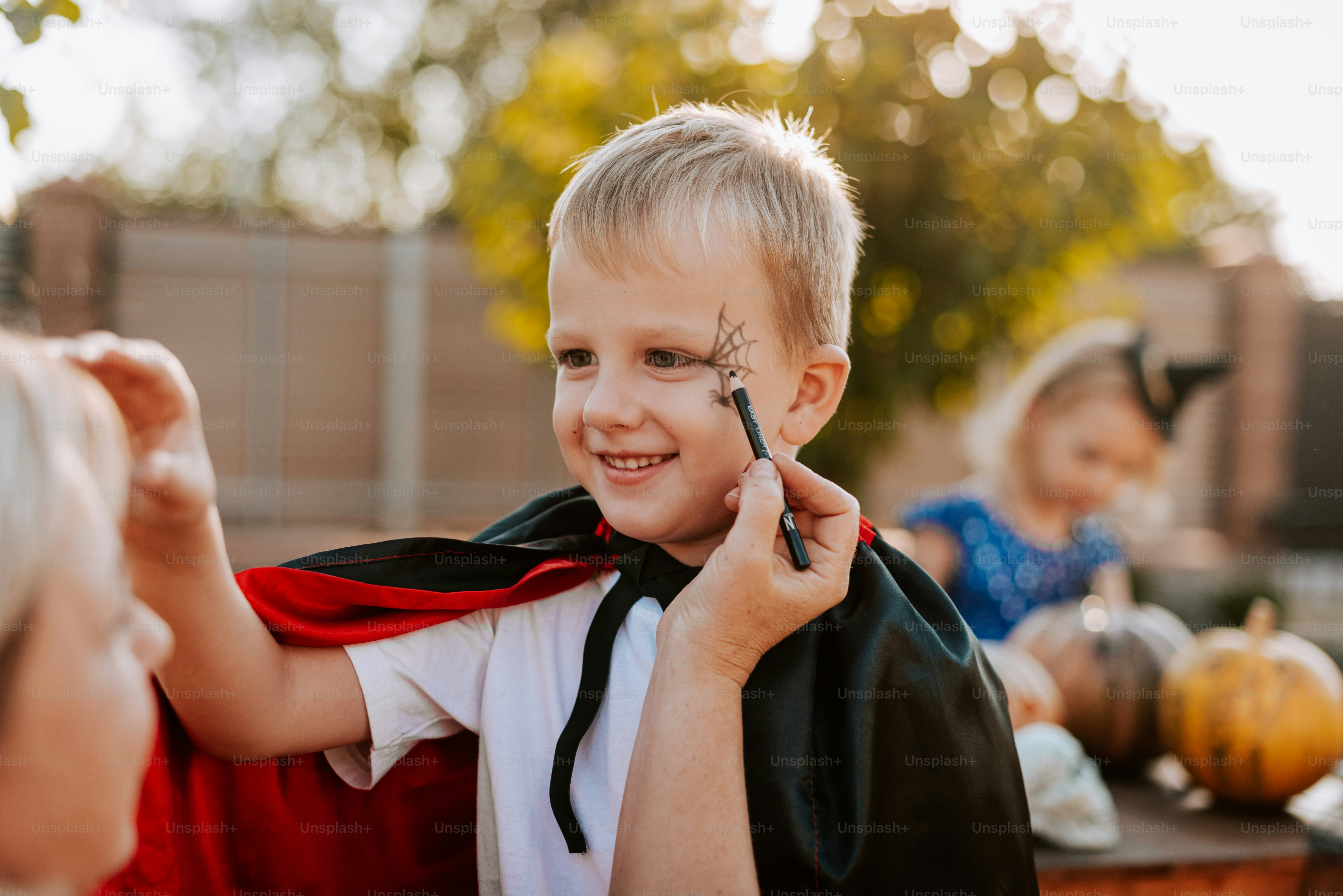 A little boy with a cape around his neck