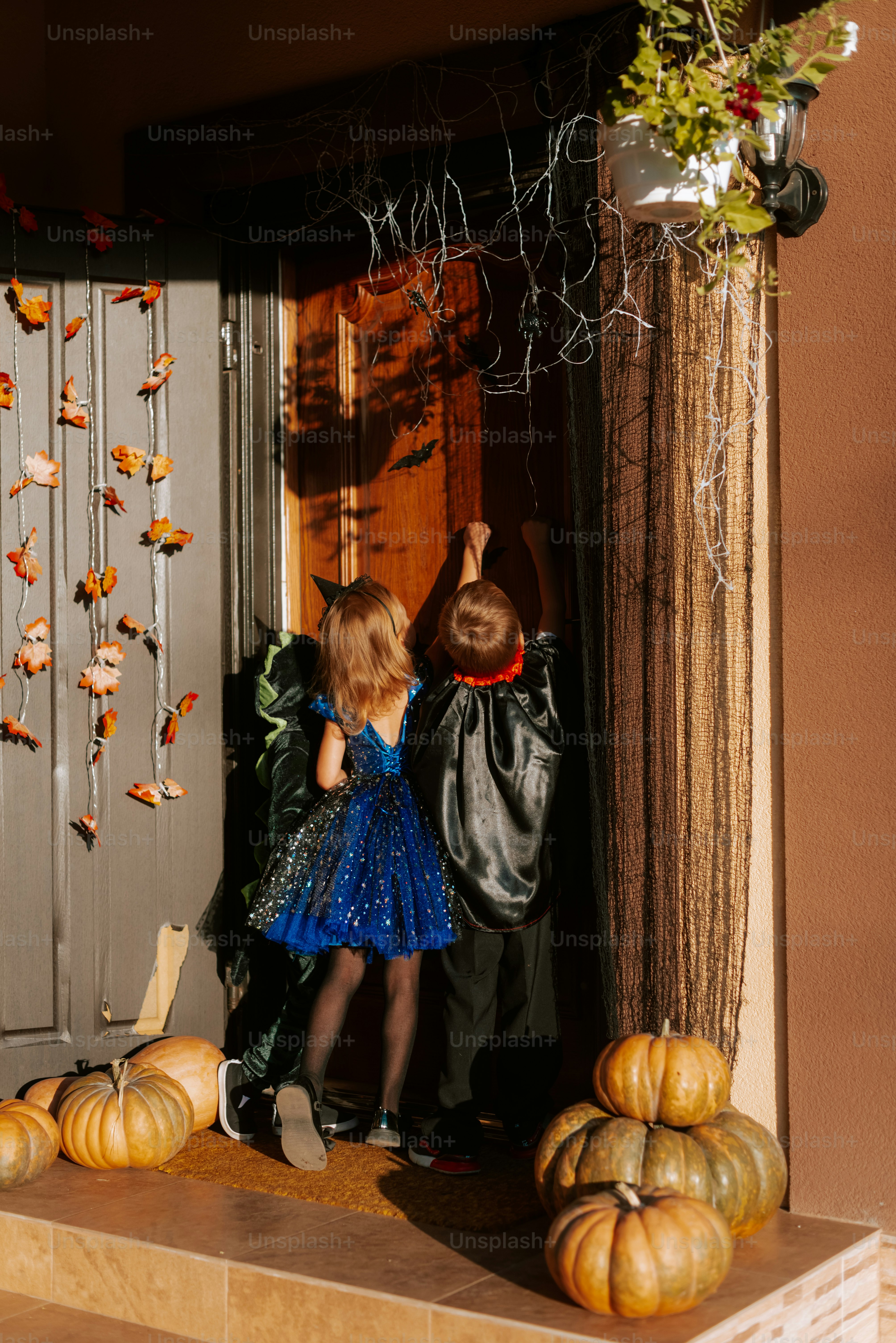 A couple of kids standing in front of a door
