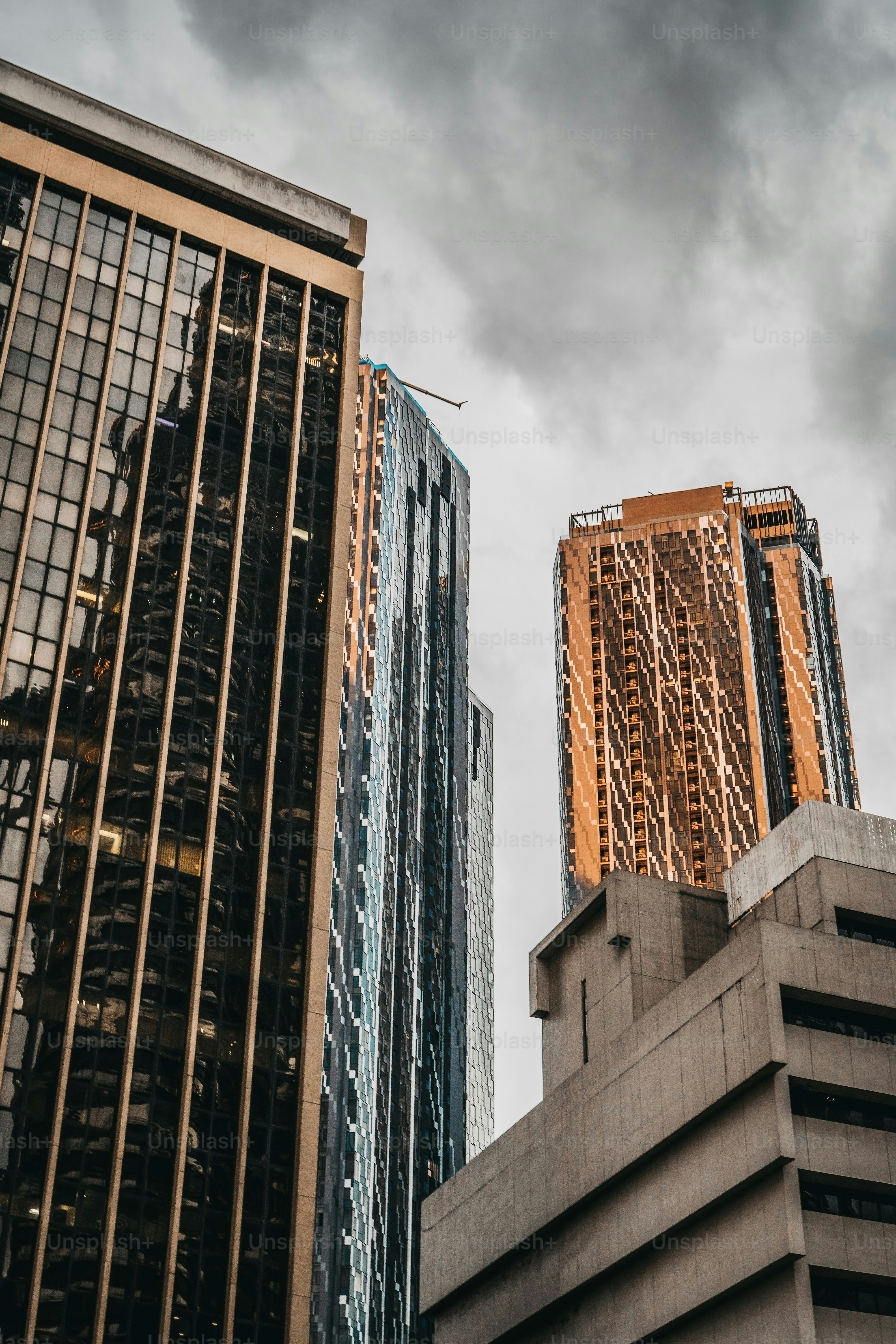 A couple of tall buildings under a cloudy sky