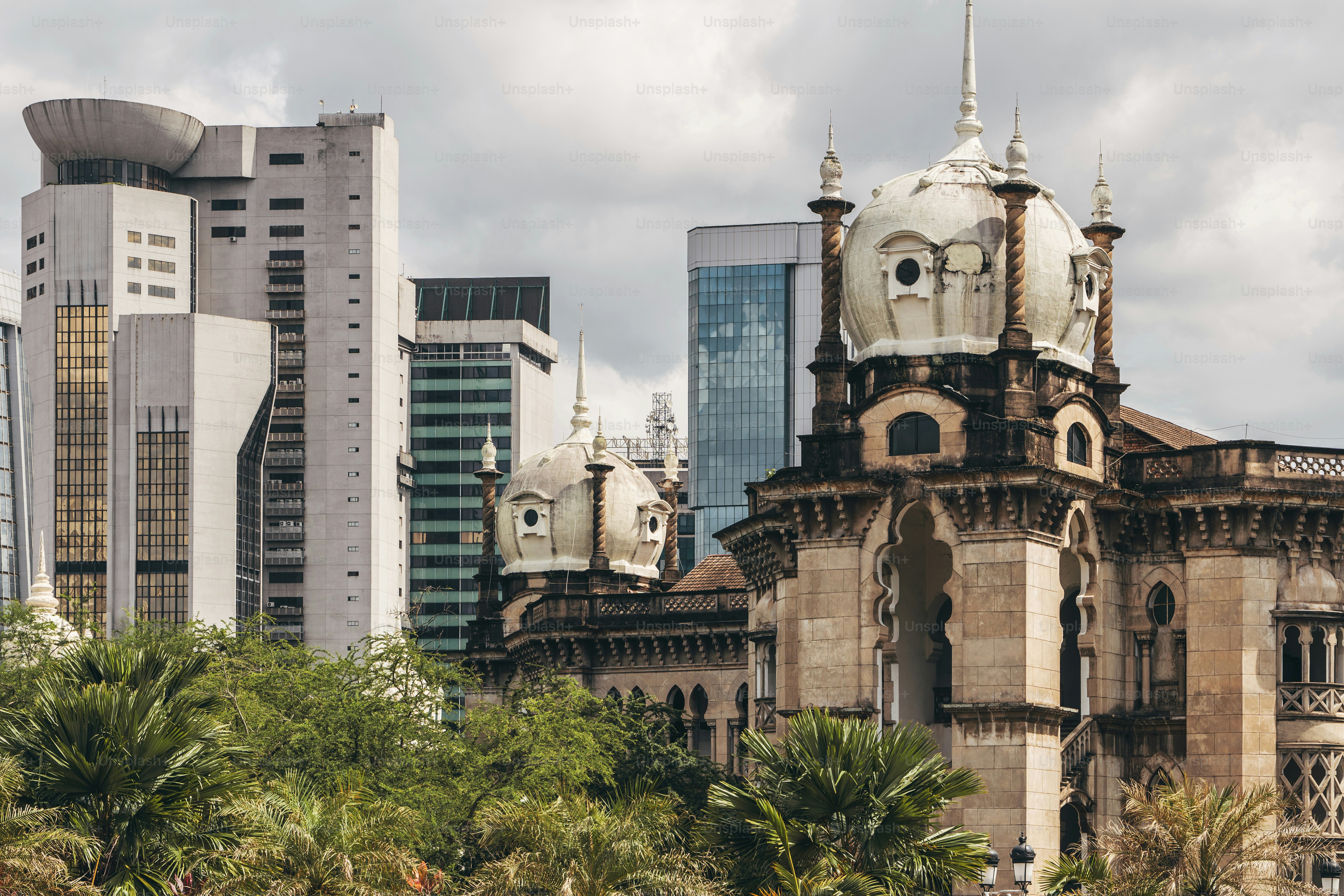 A large building with a clock tower in the middle of a city