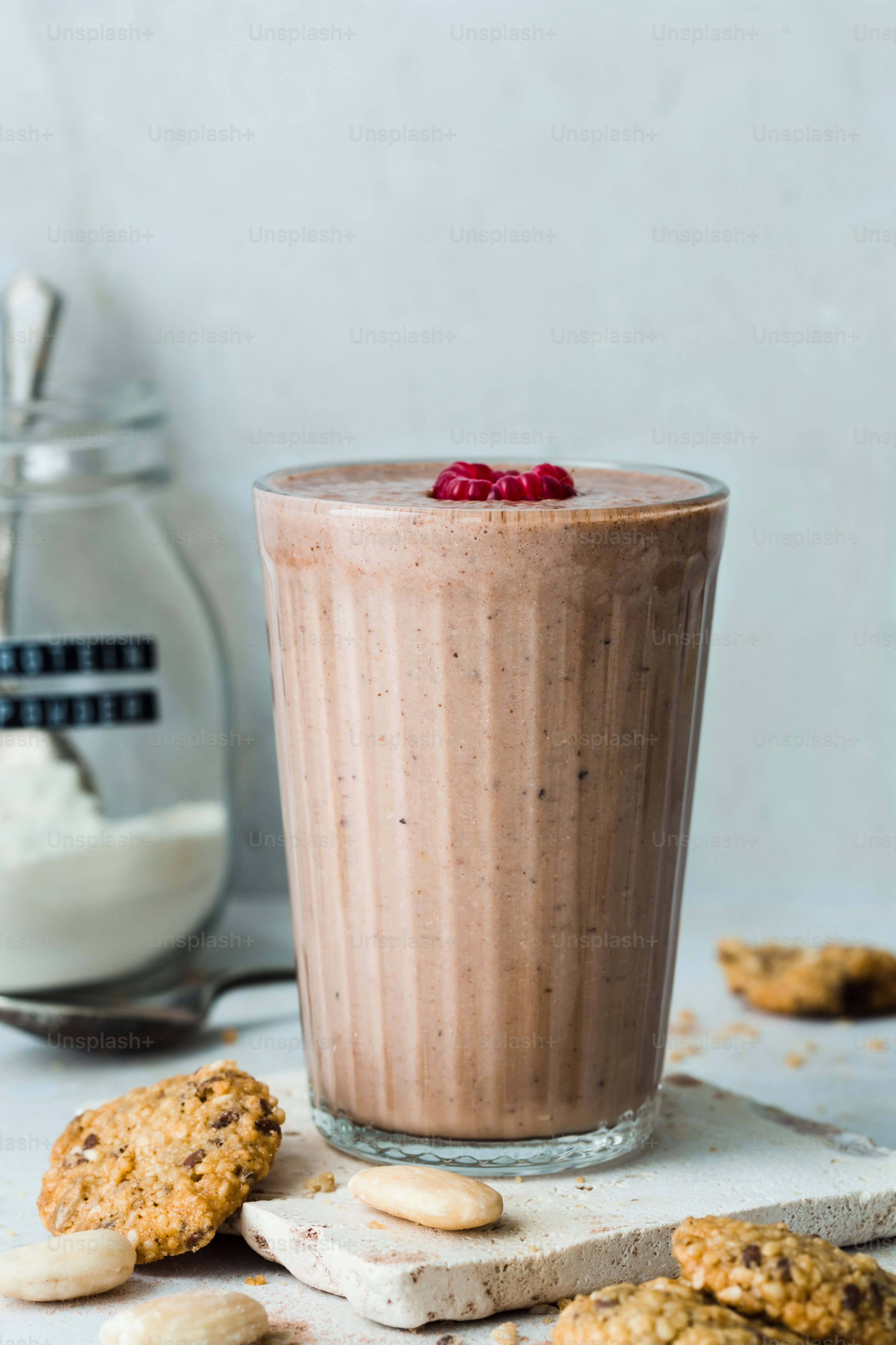 A smoothie and cookies on a table