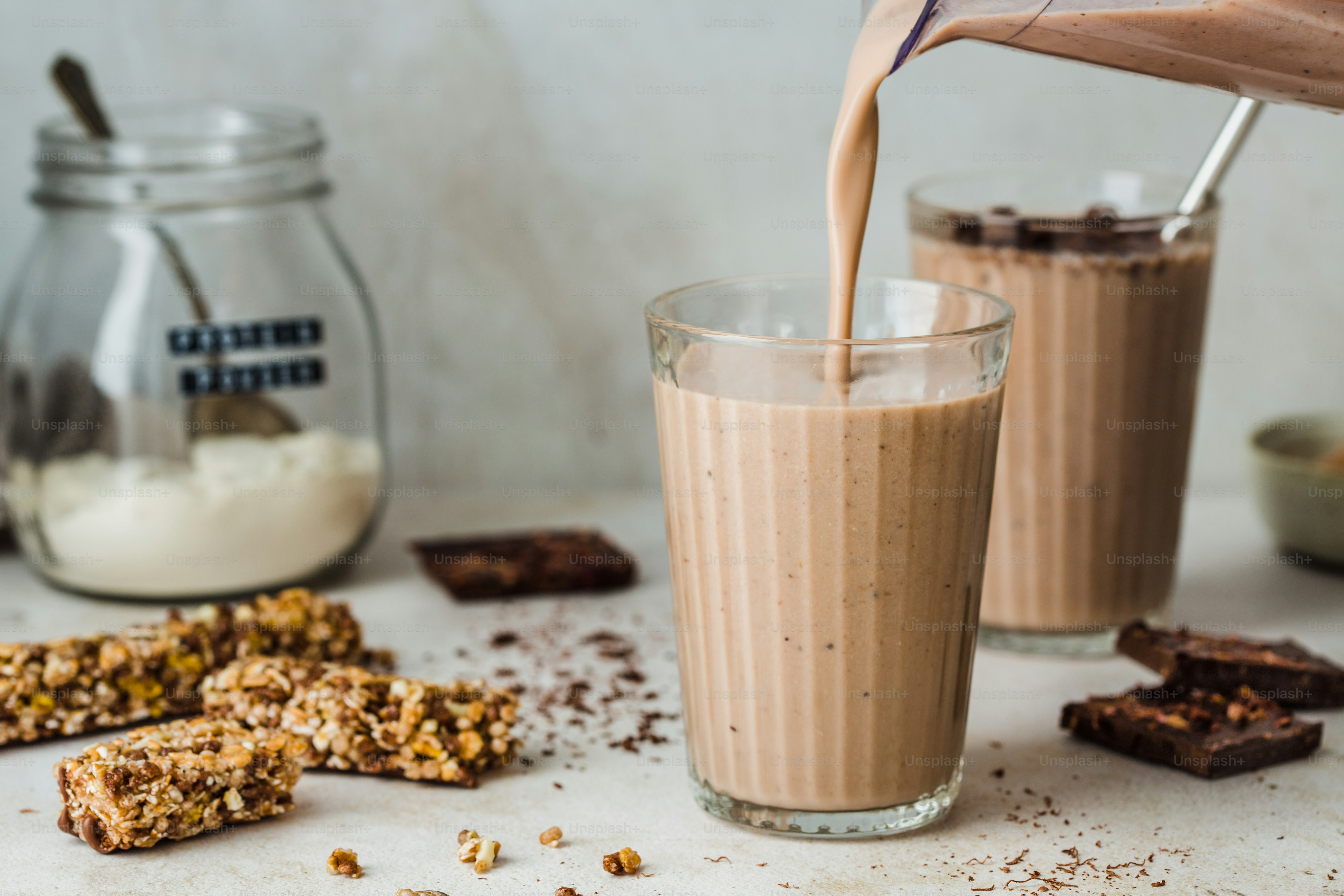 A glass of milk being poured into a glass