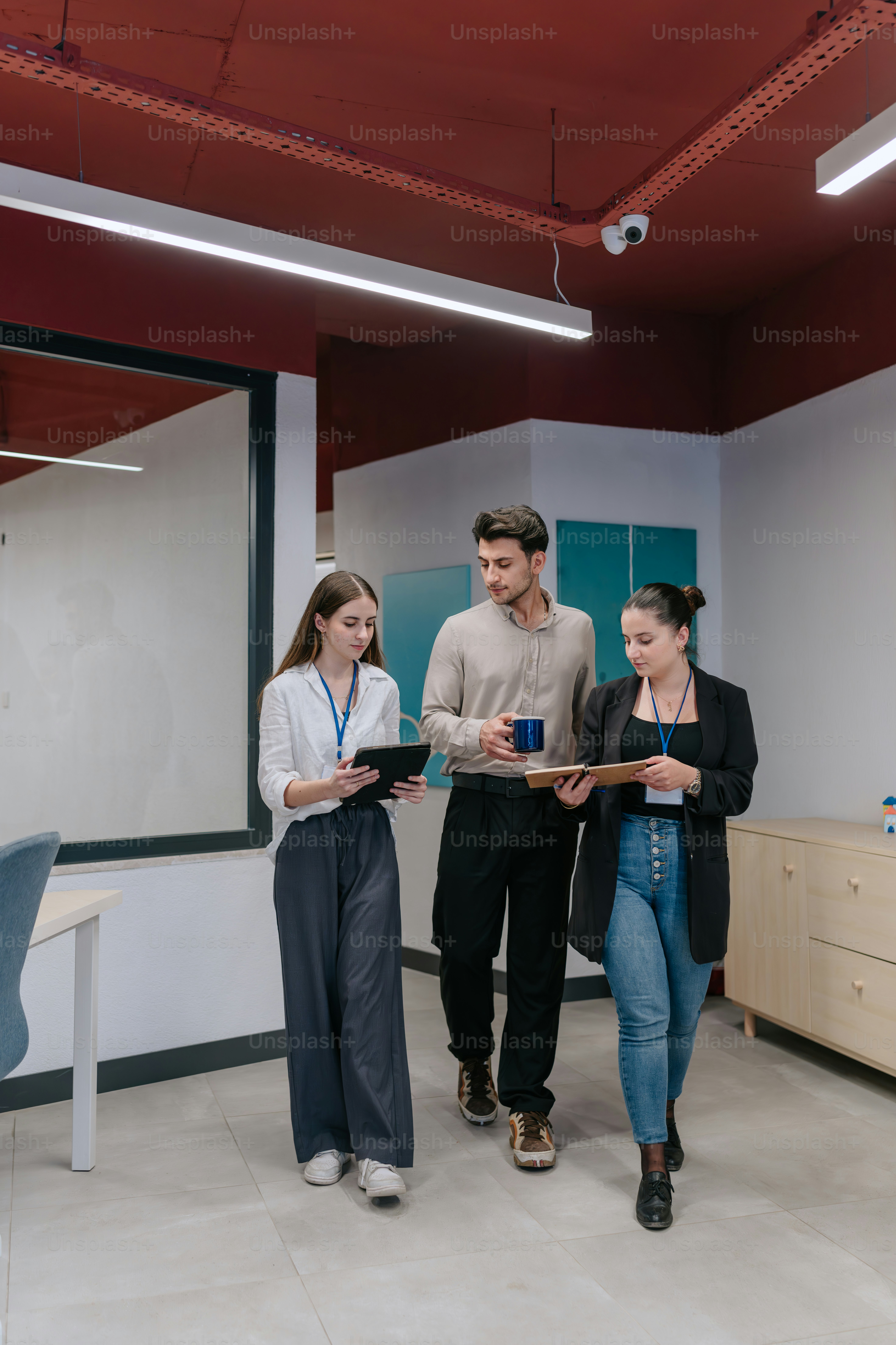 A group of people standing in a room photo – Office Image on Unsplash