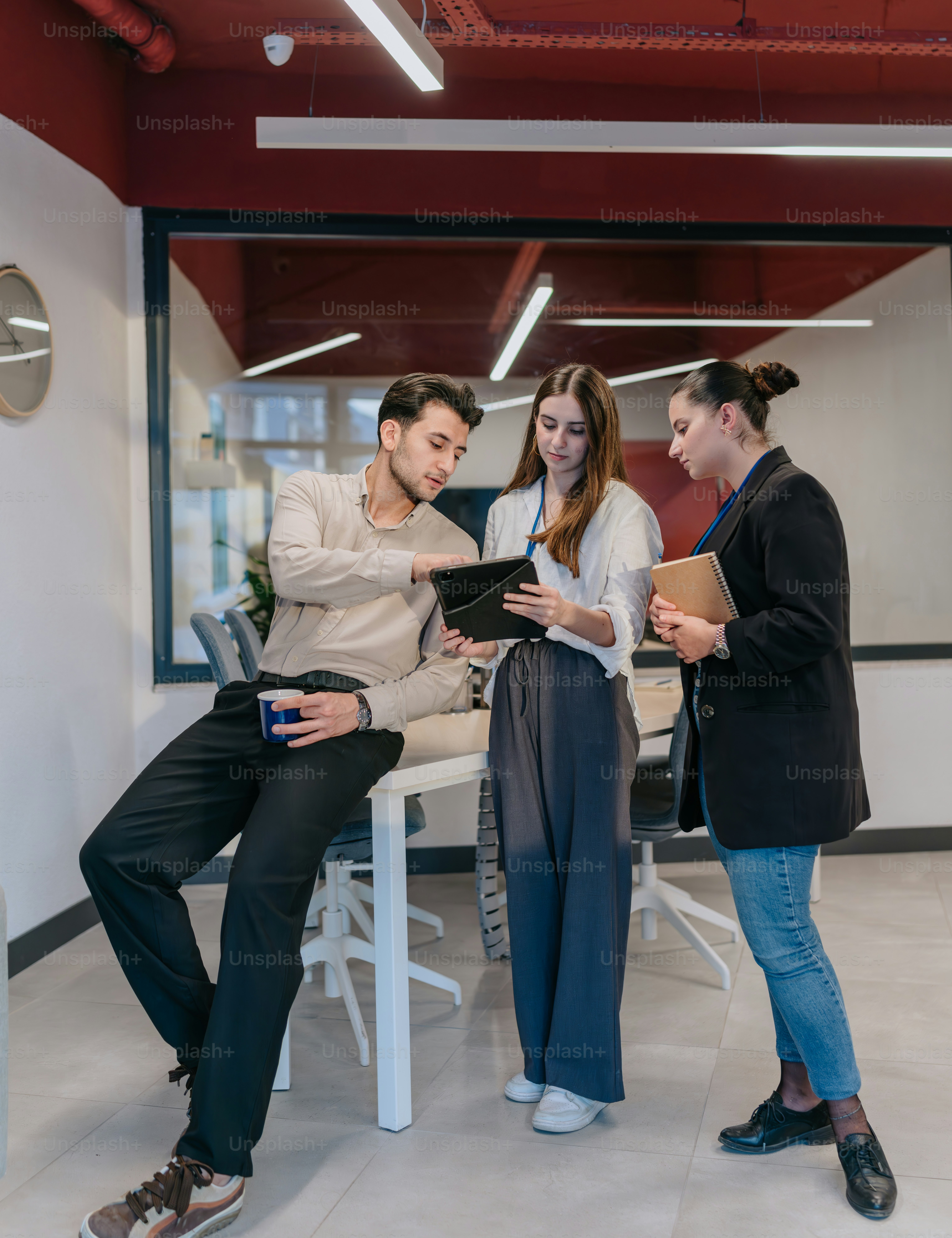 A group of people standing around a table