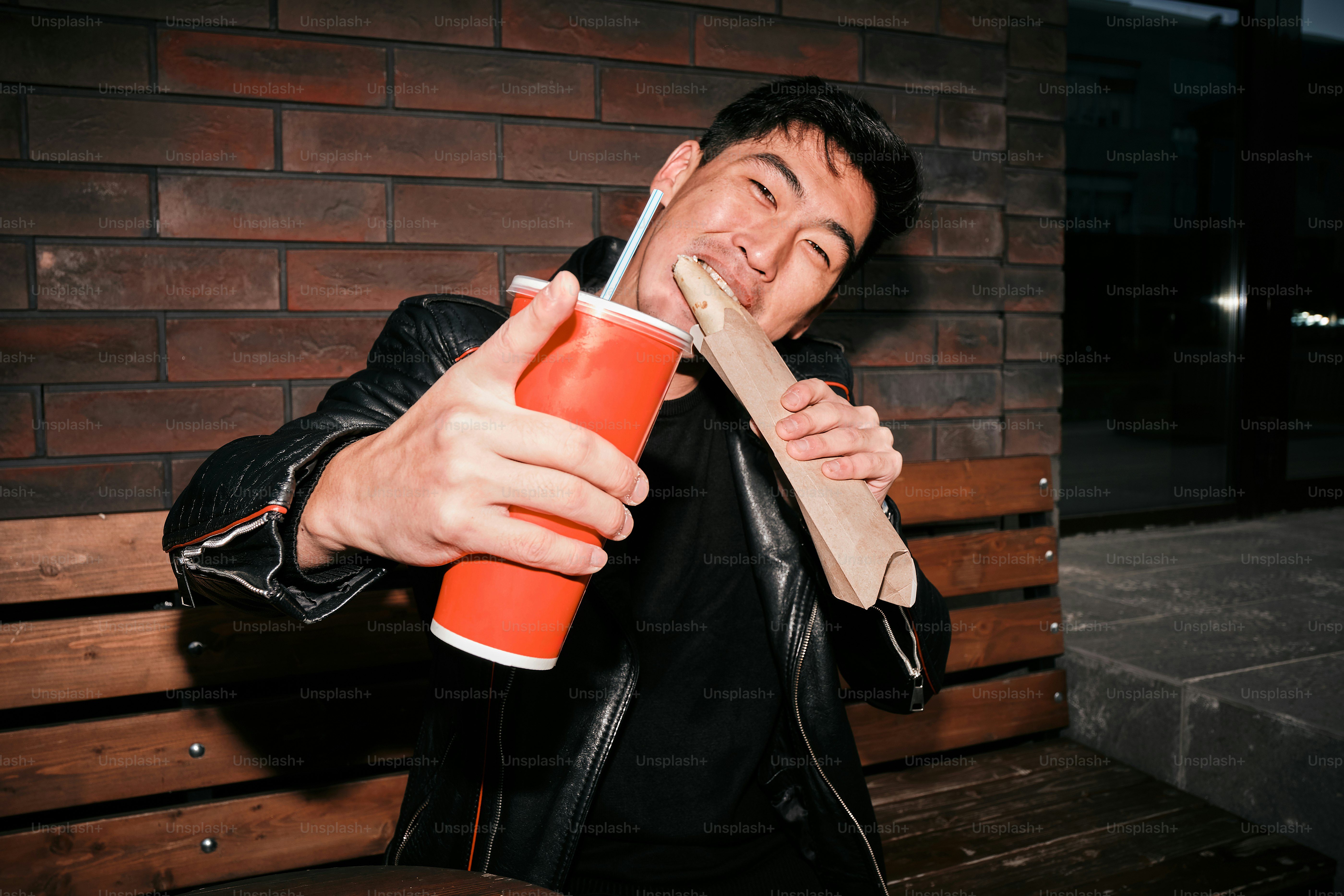 A man is holding a drink and smiling