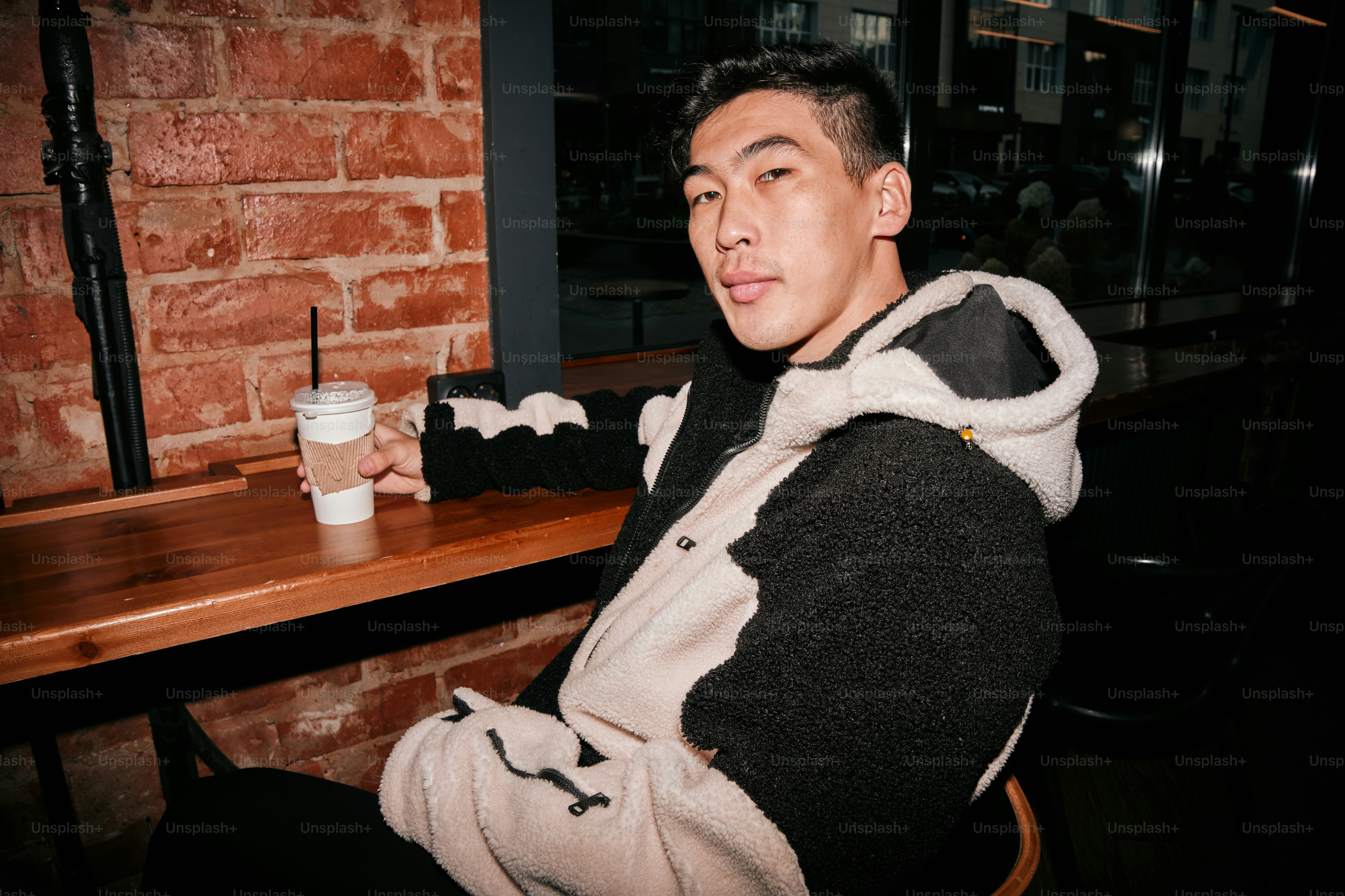 A man sitting at a table with a drink