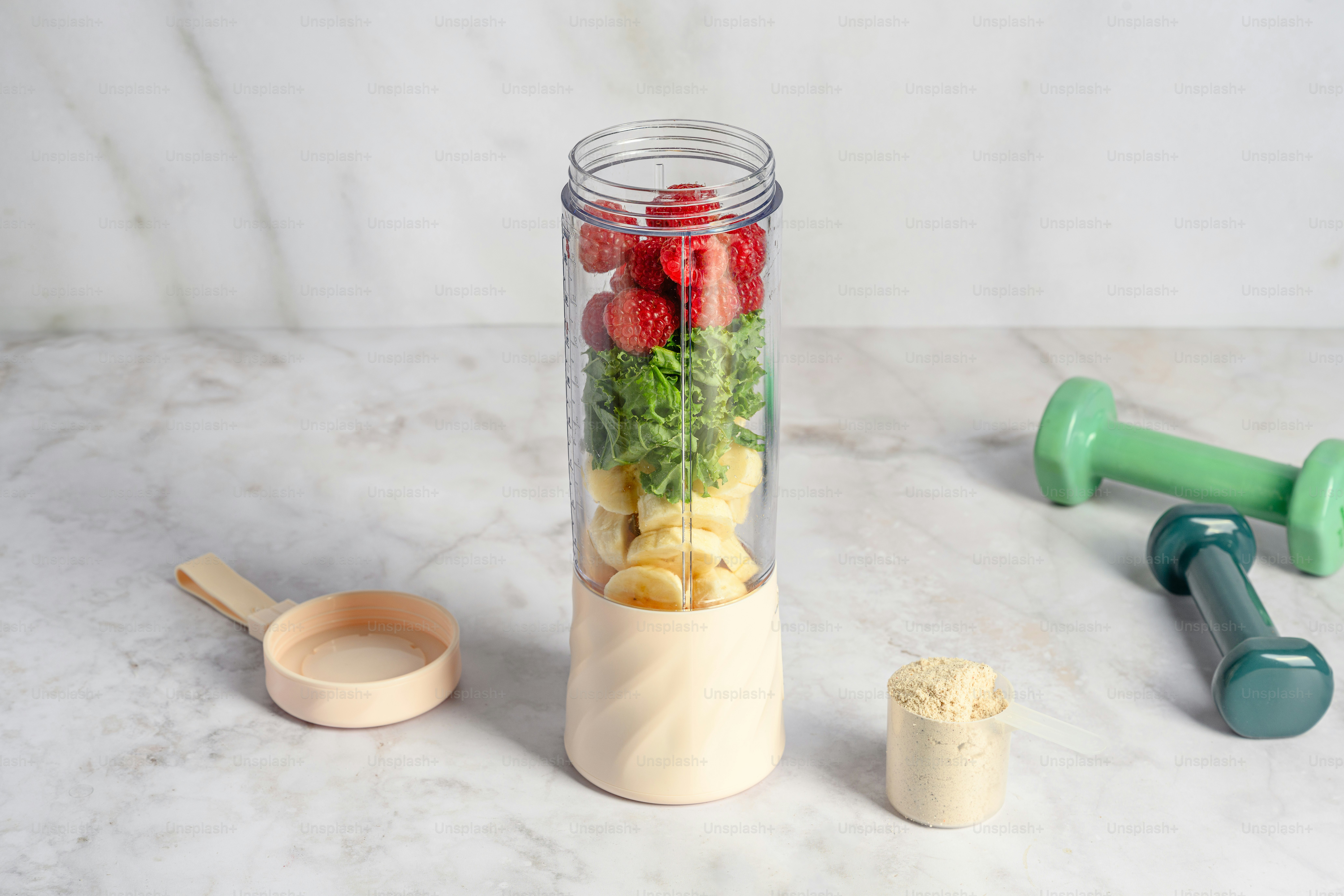A blender filled with fruits and vegetables on a counter