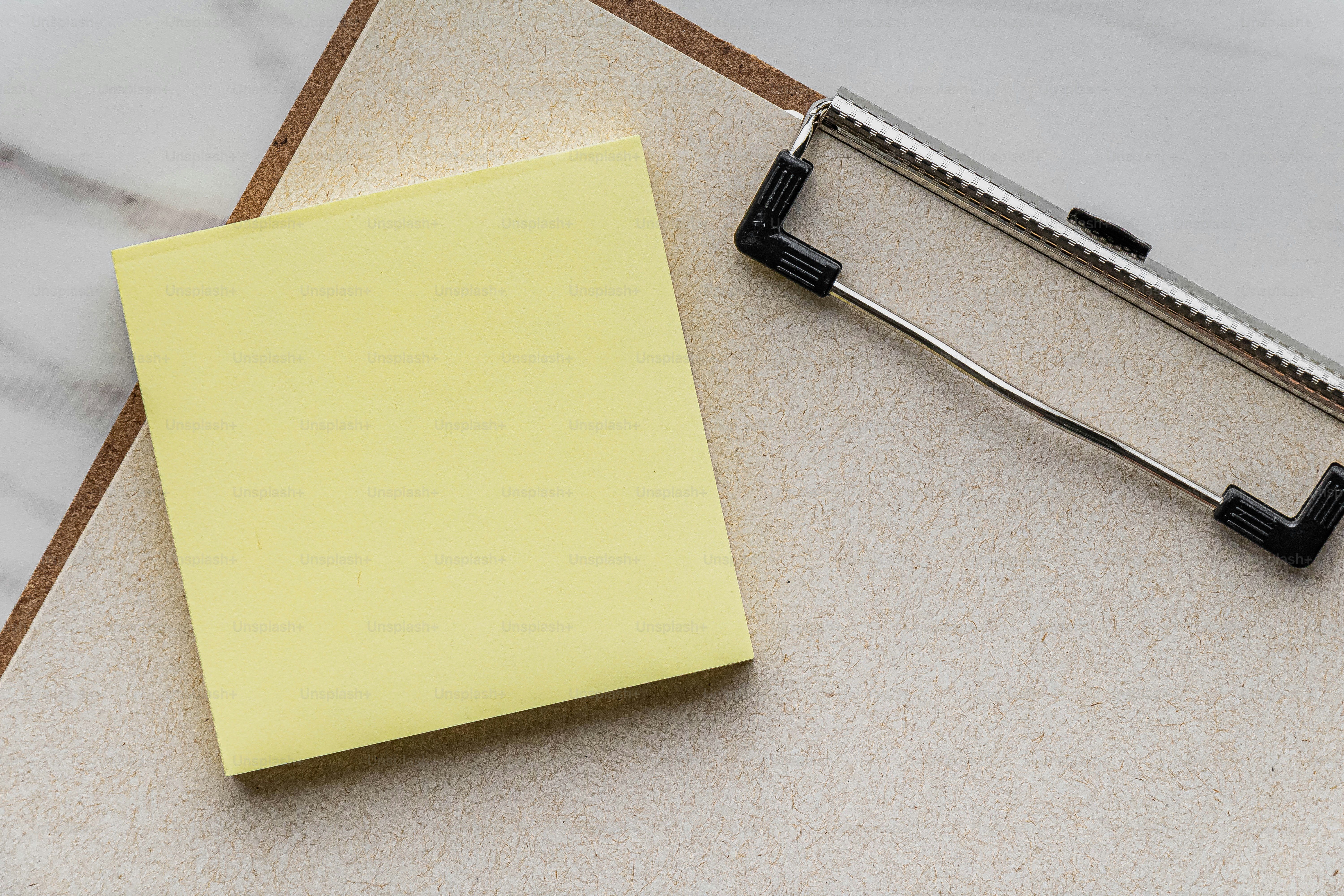 A note pad and a stapler on a table