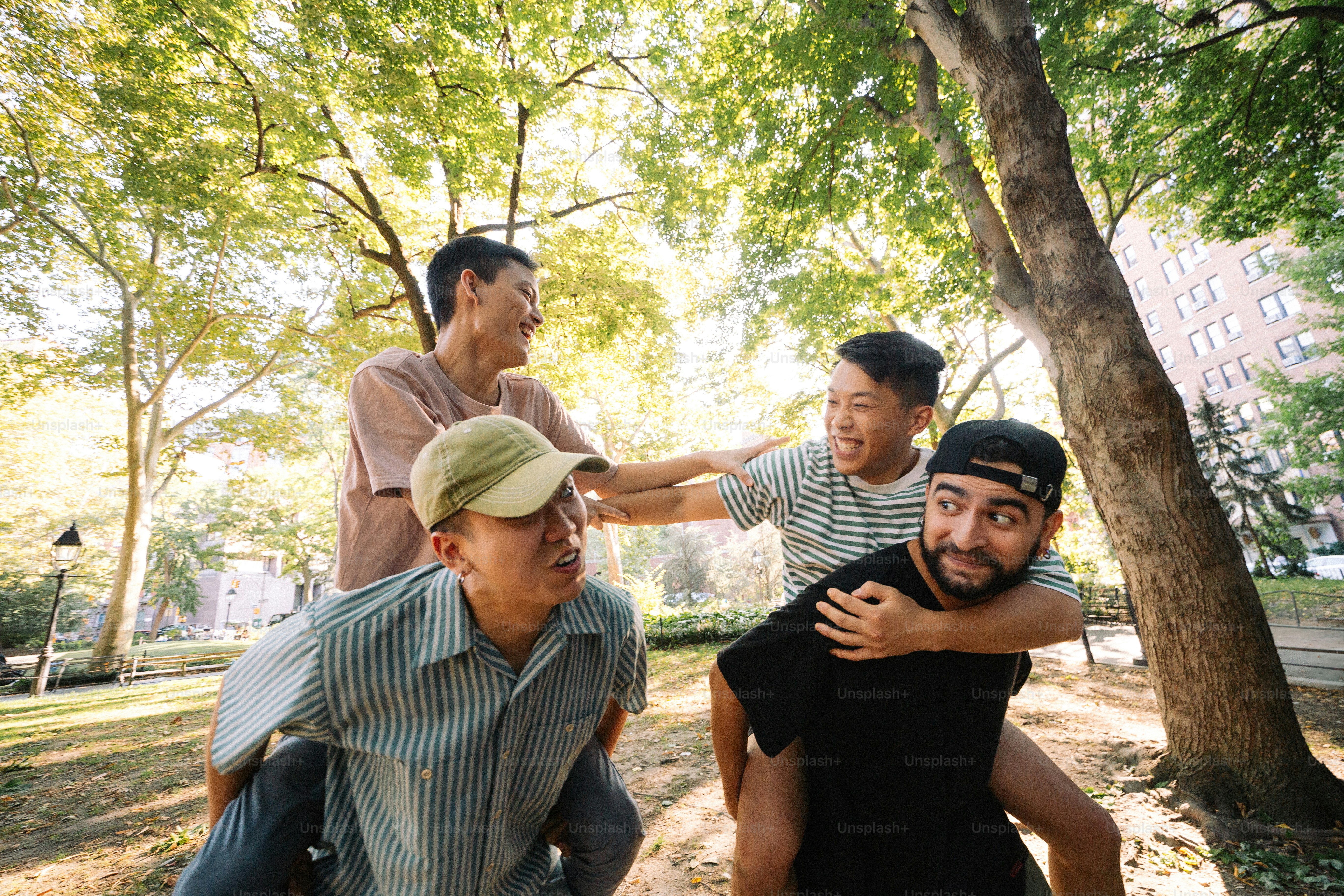 A group of young men standing next to each other in a park