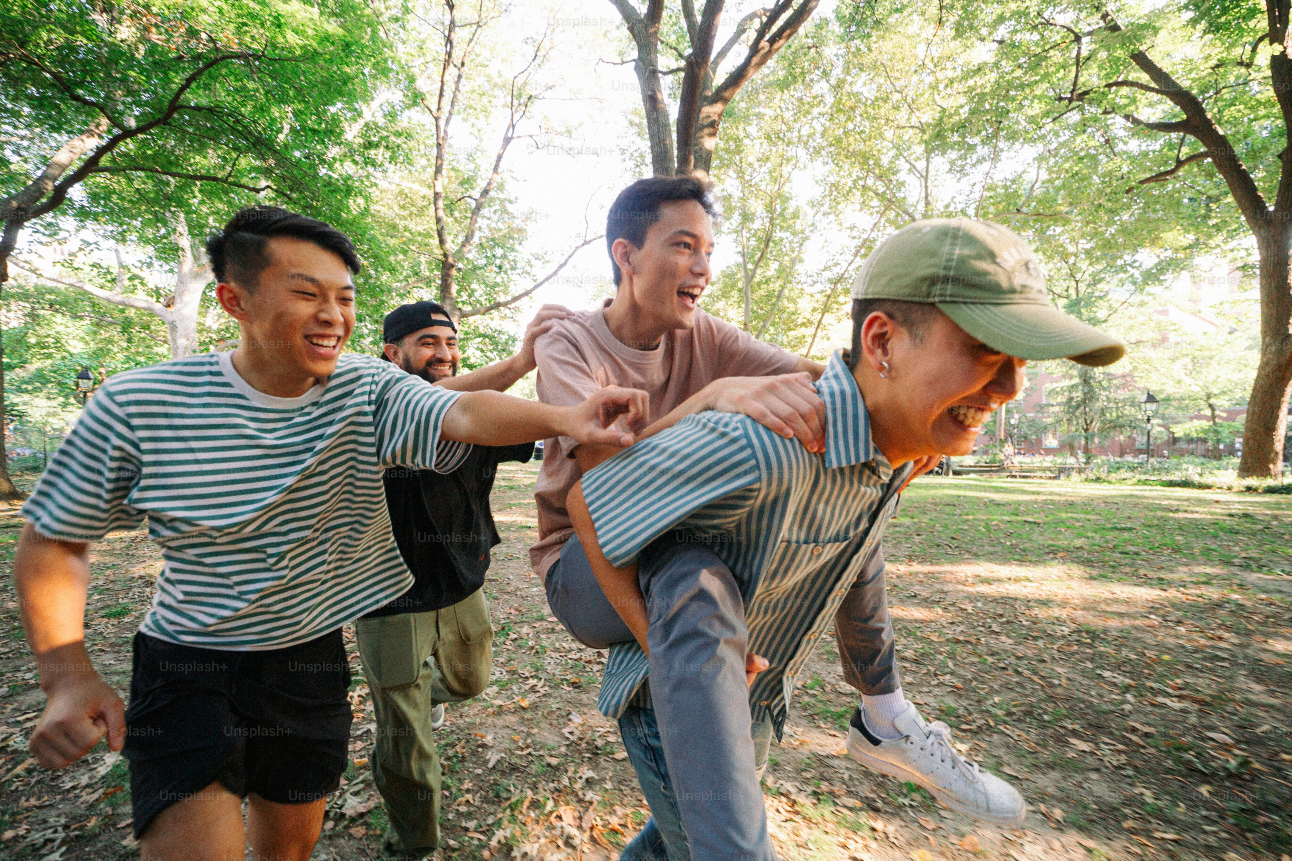 A group of men playing tug of war in a park