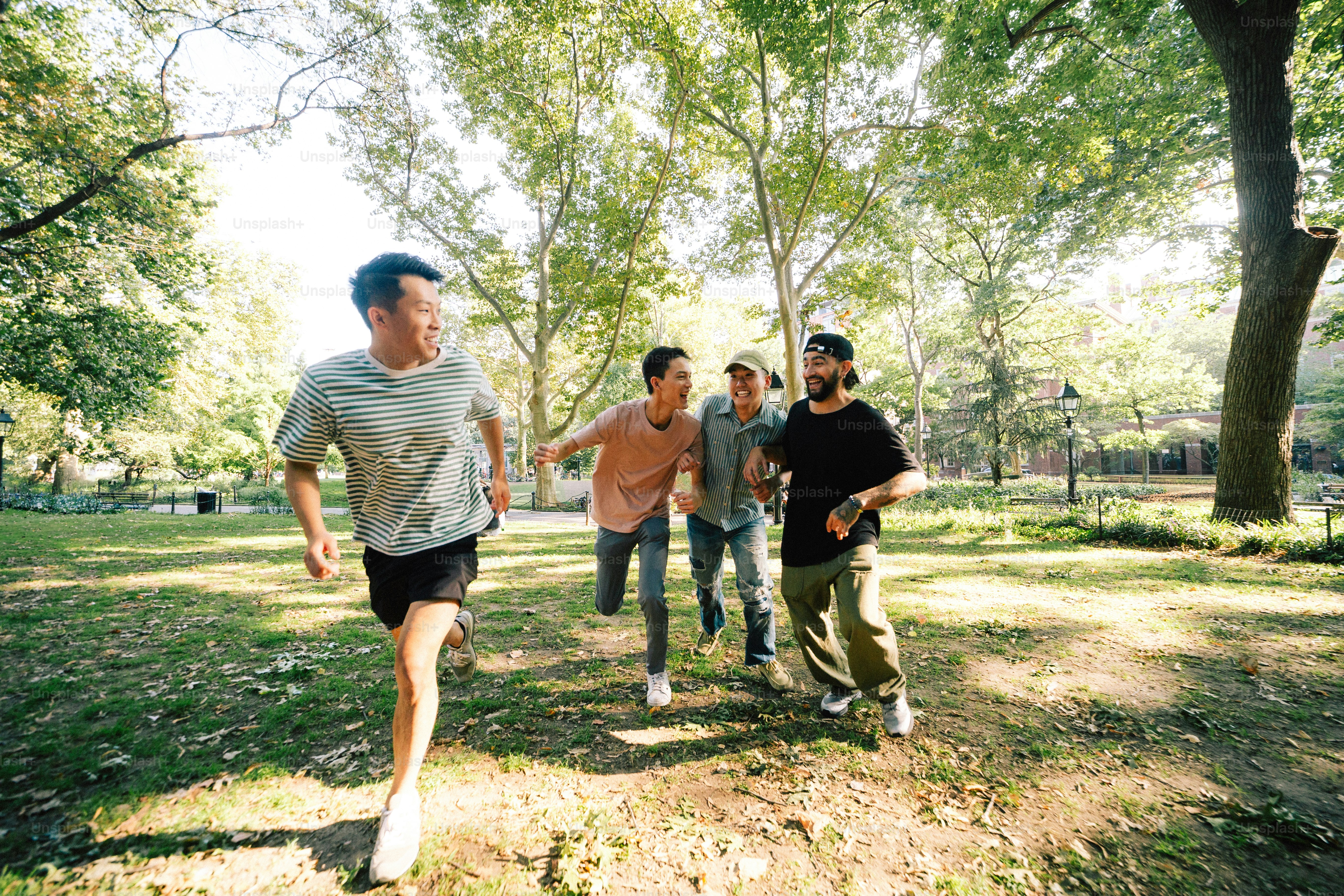 A group of men running through a park