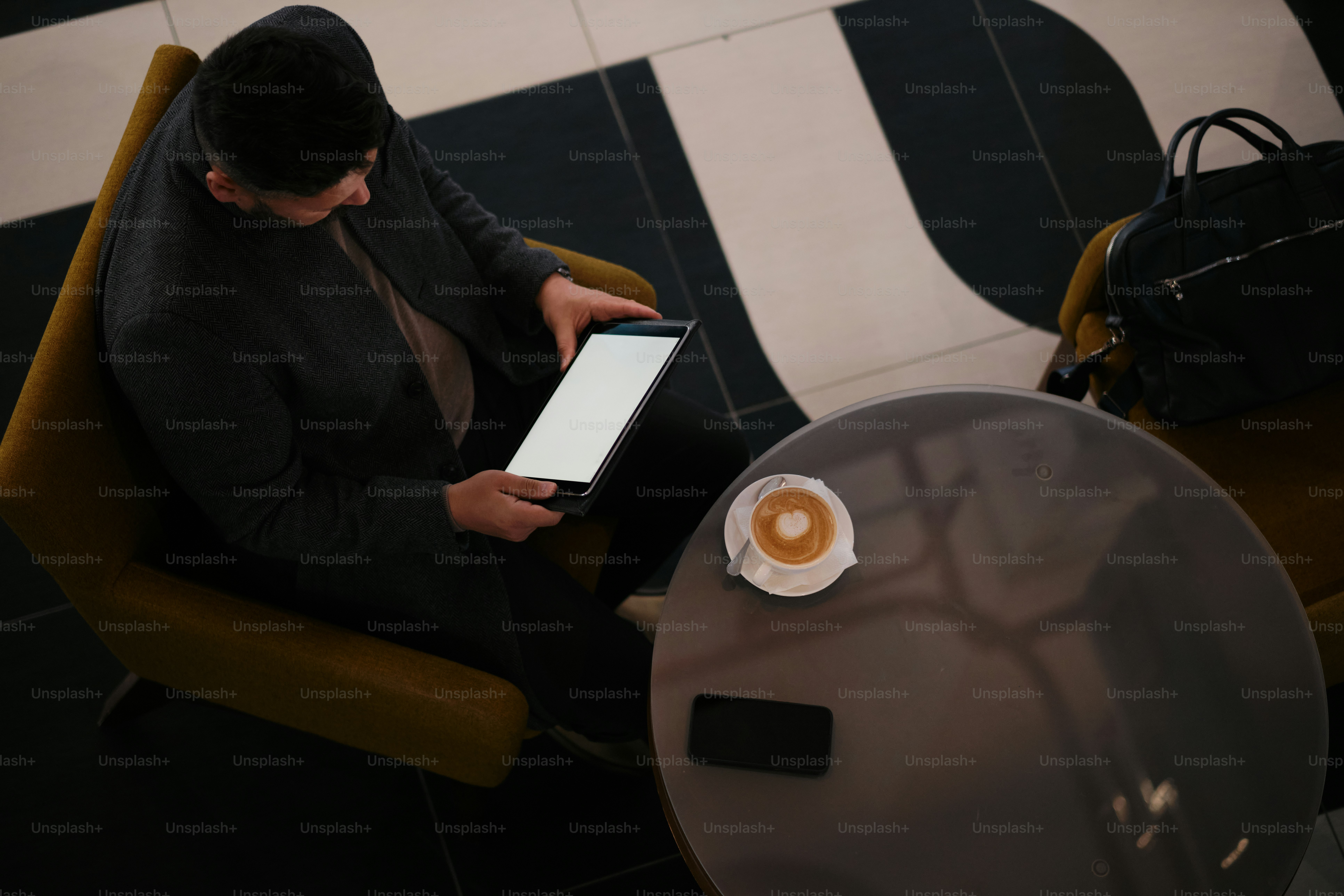 A person sitting in a chair with a tablet