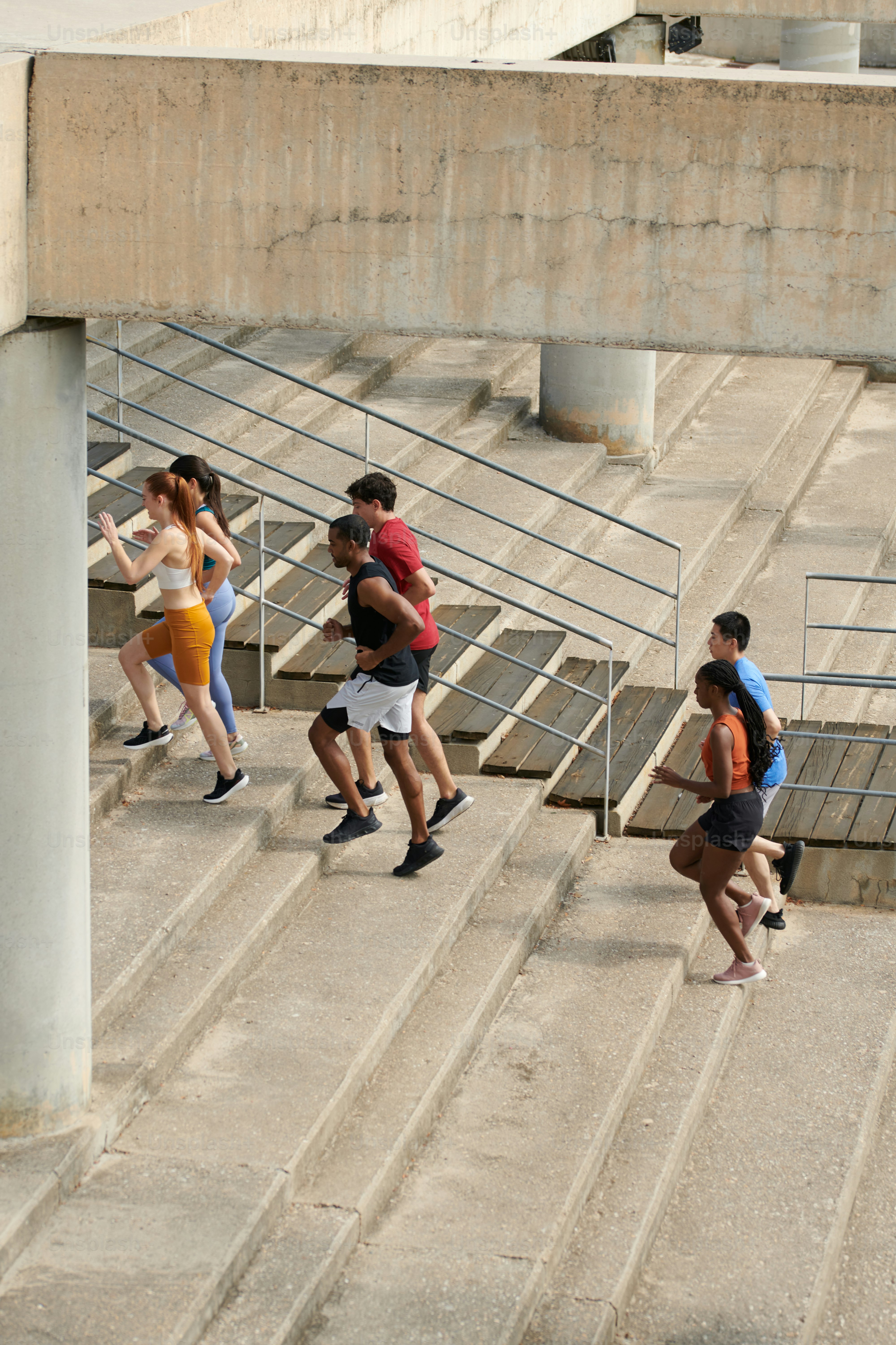 A group of people walking up some stairs
