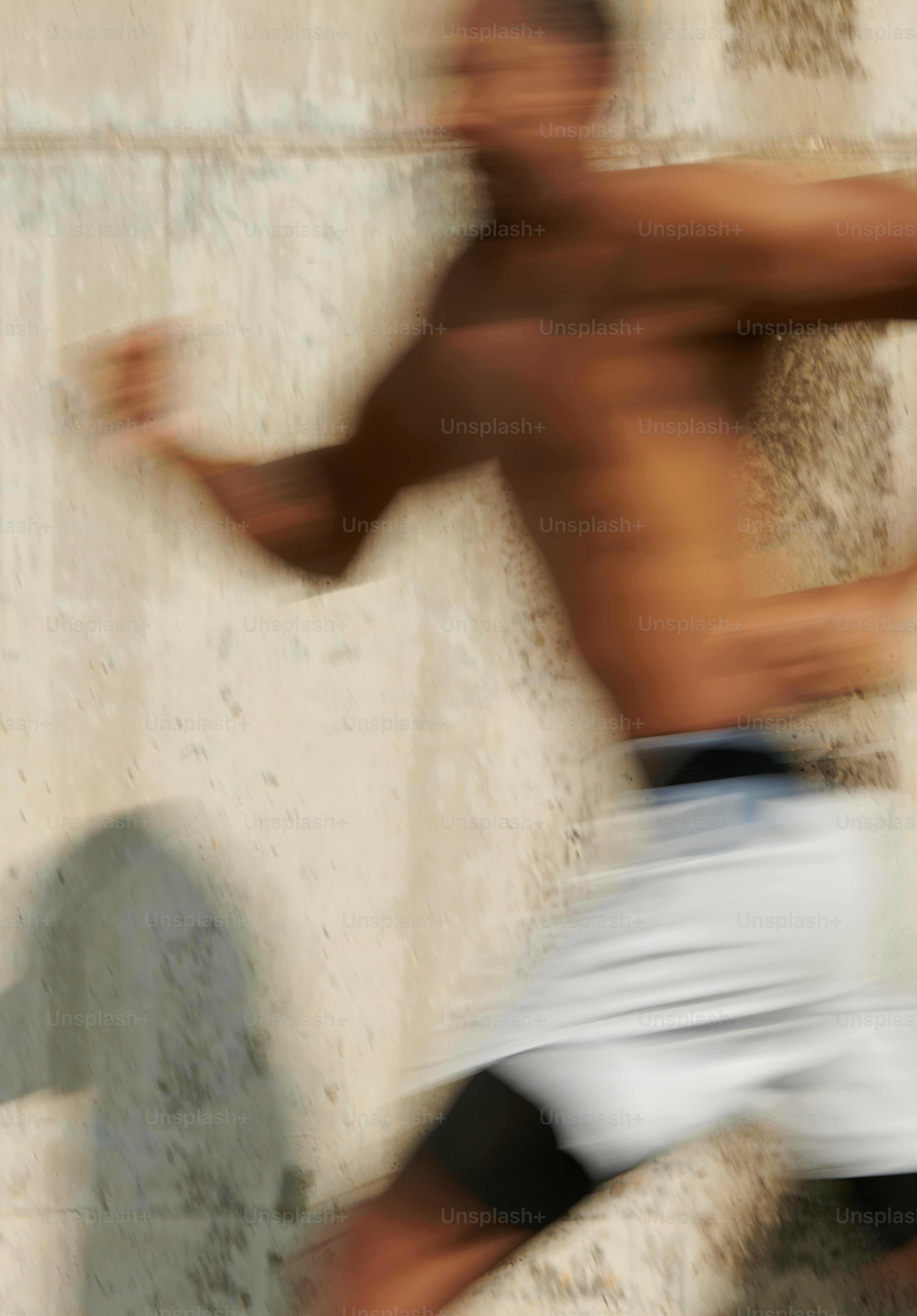 A blurry photo of a shirtless man running
