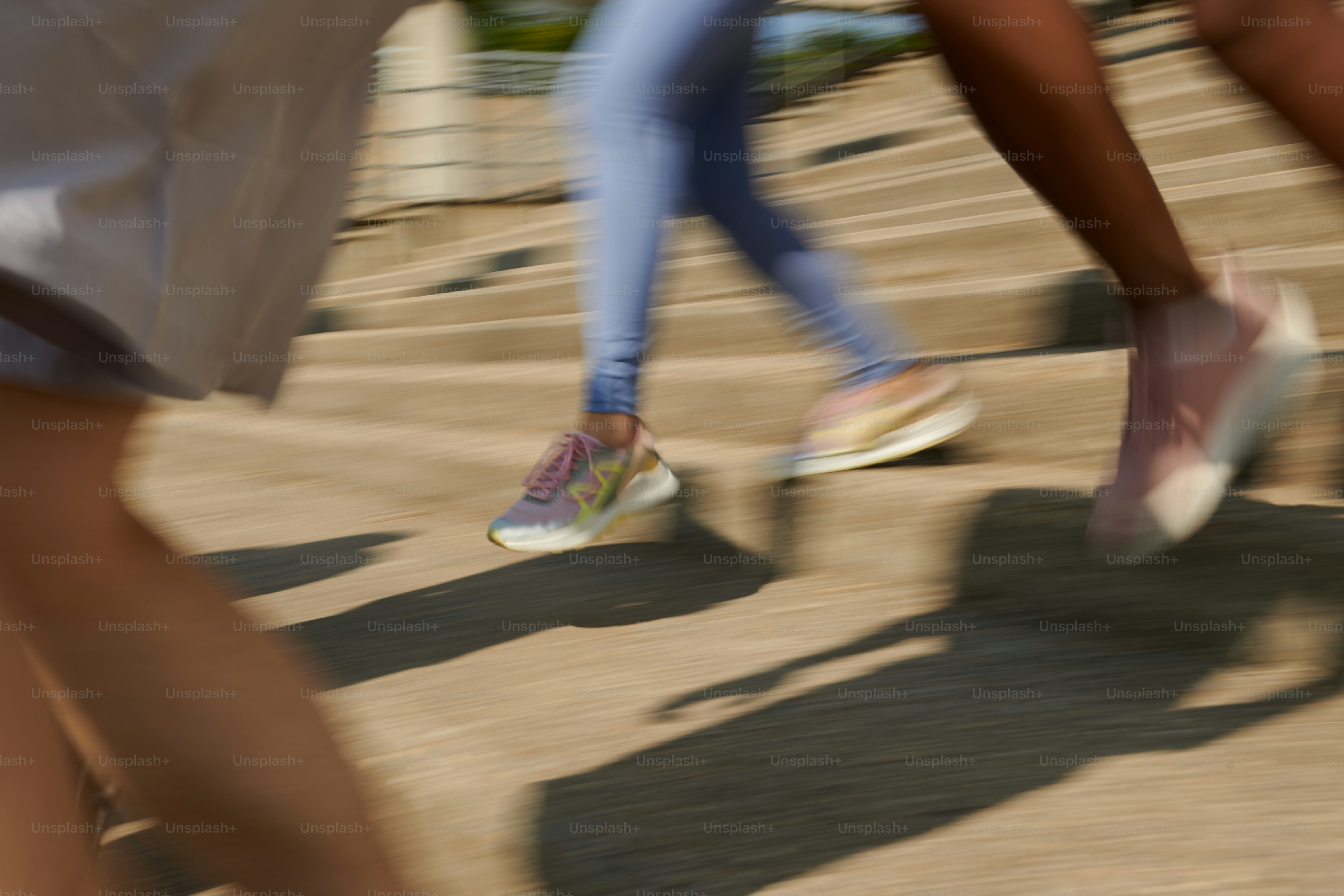 A group of people walking down a sidewalk