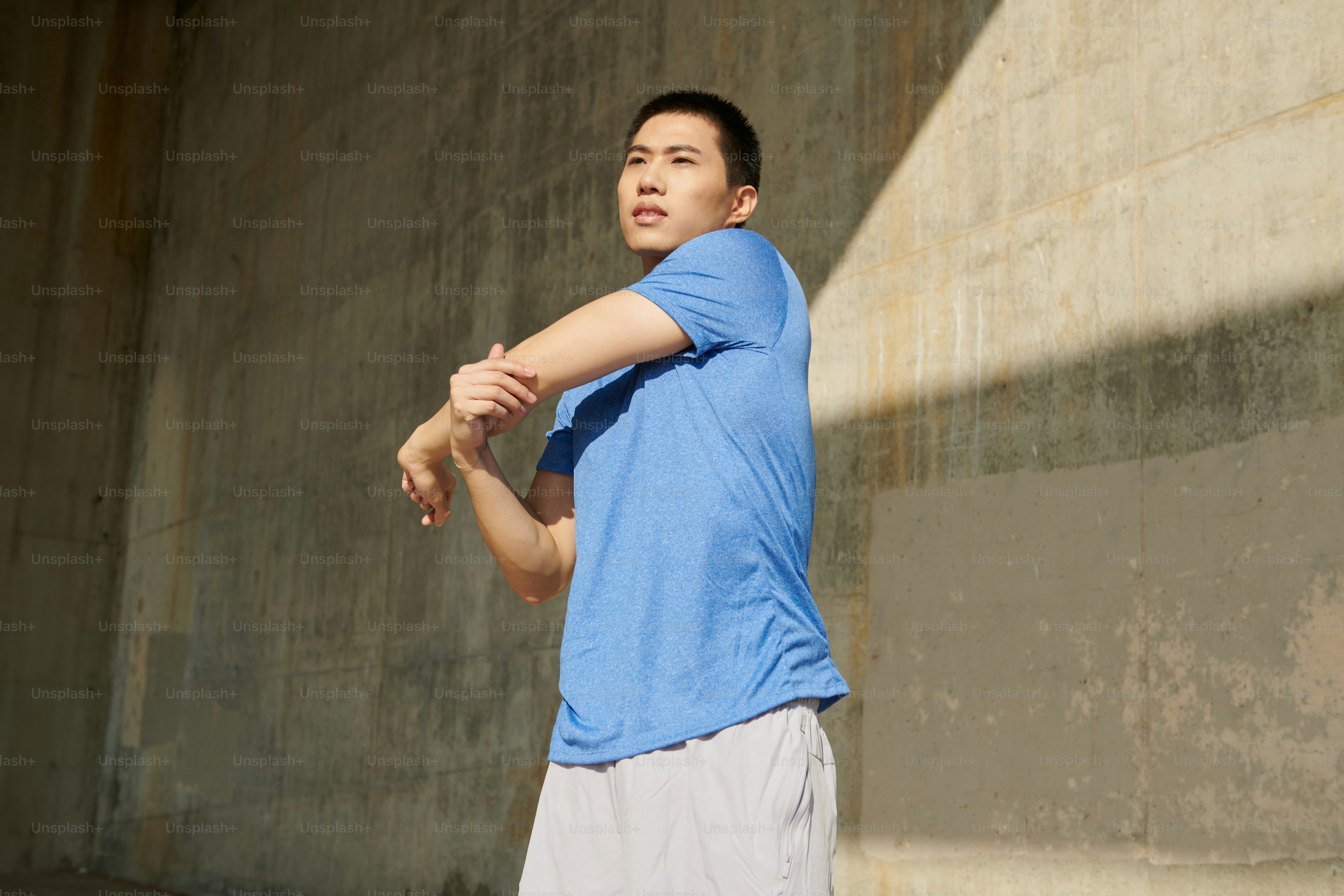 A man in a blue shirt holding a baseball bat