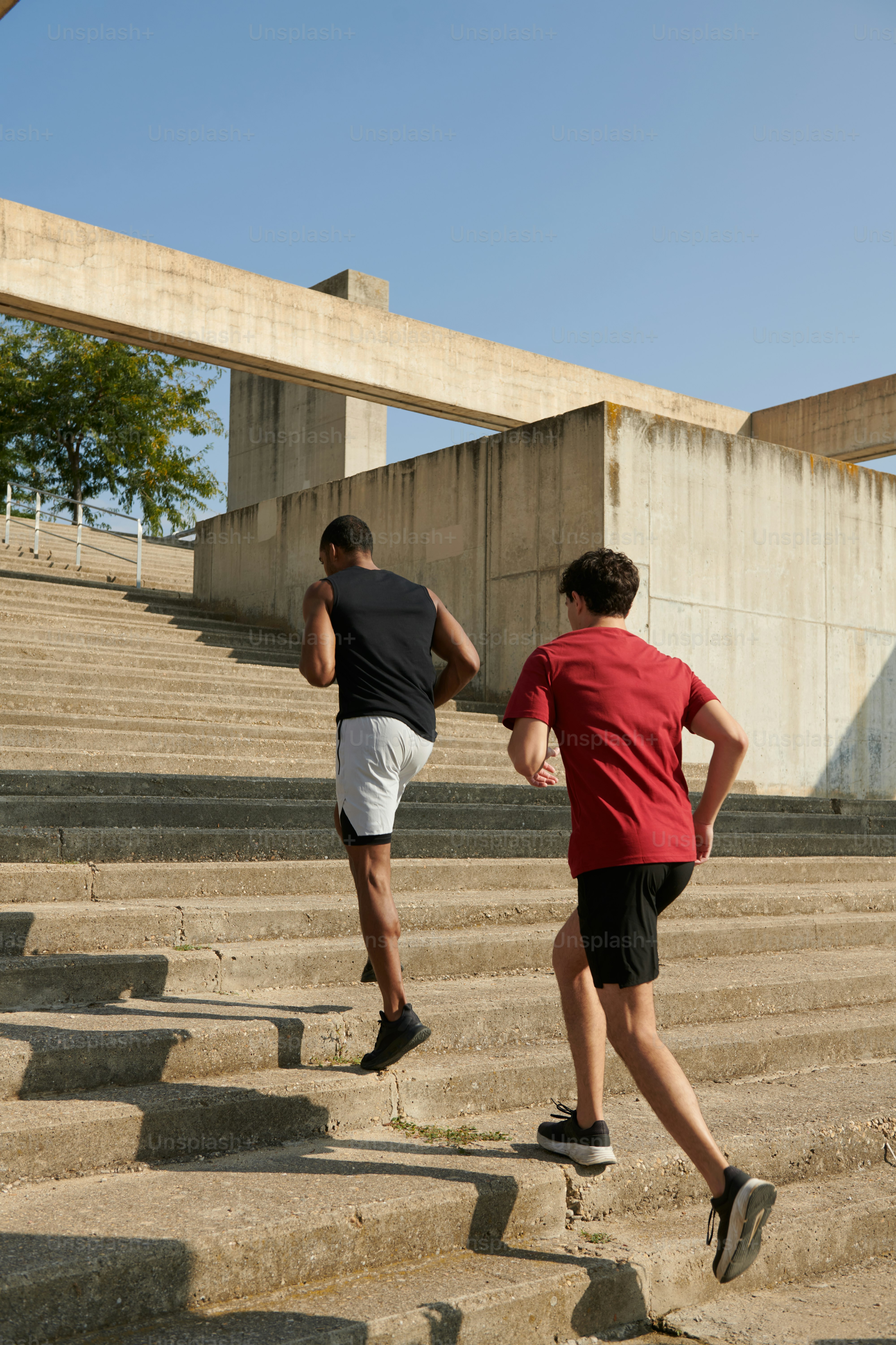 A couple of people that are running down some steps