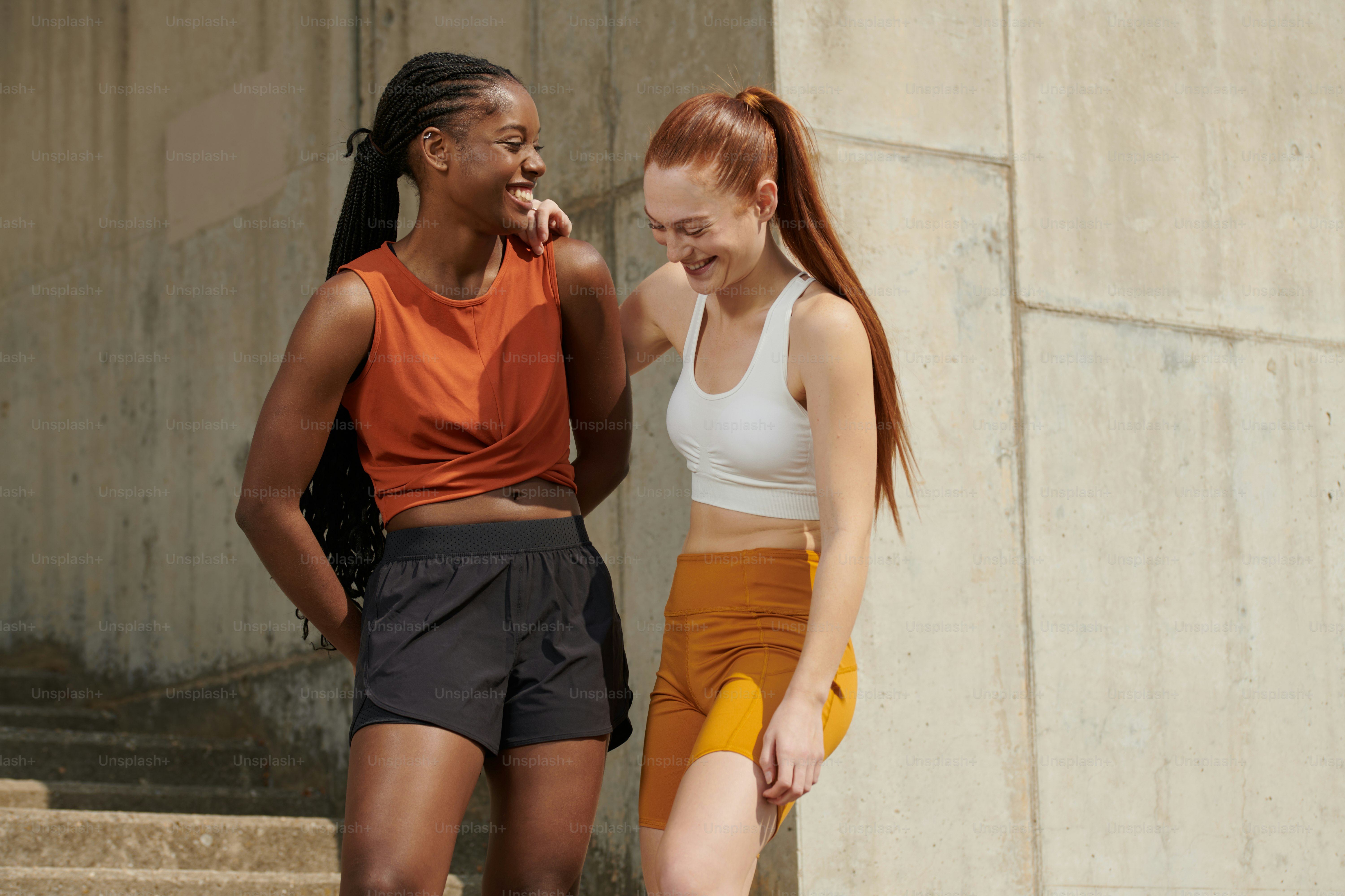 Two young women standing next to each other photo – Keeping fit Image ...