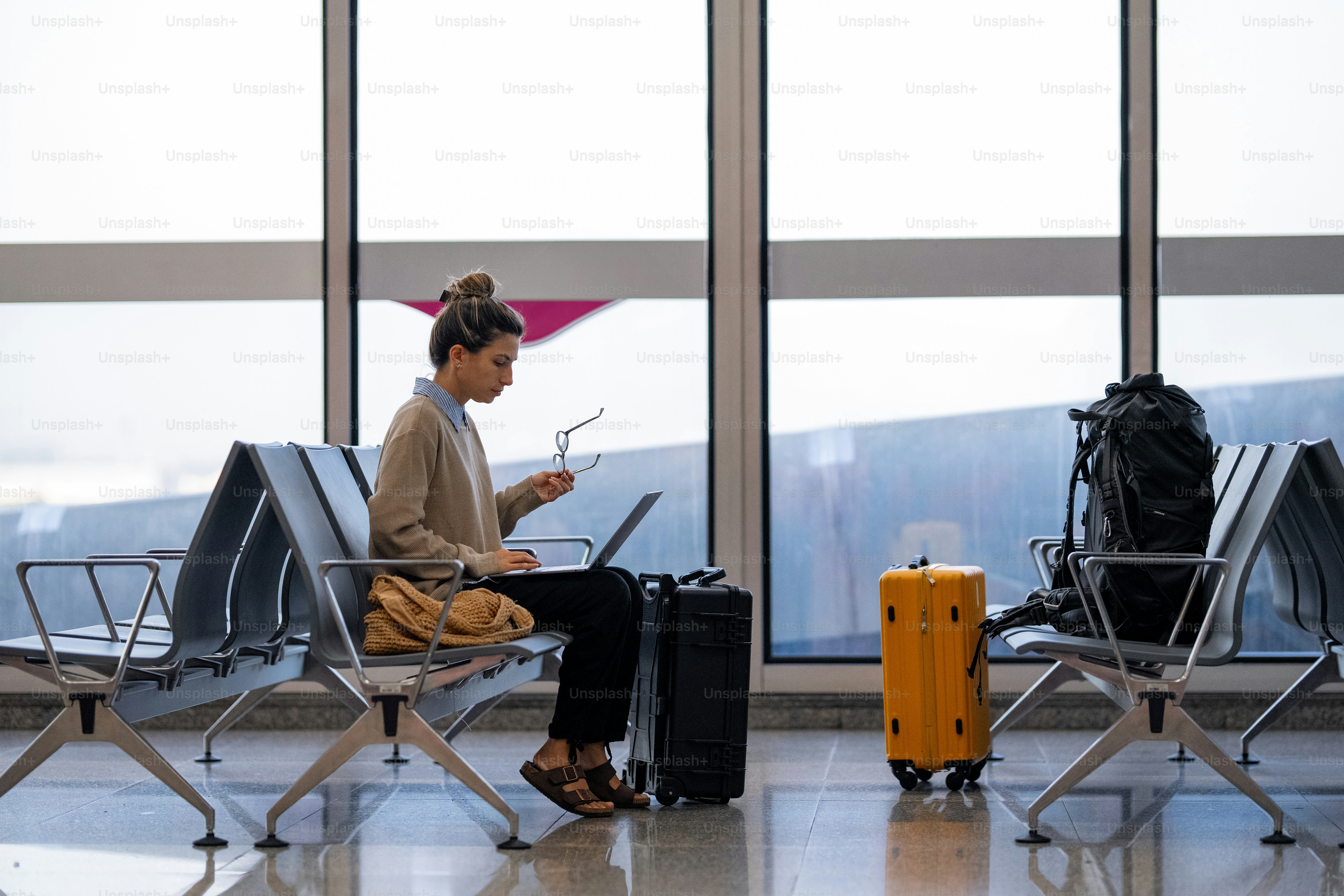 A woman sitting in a chair with a laptop