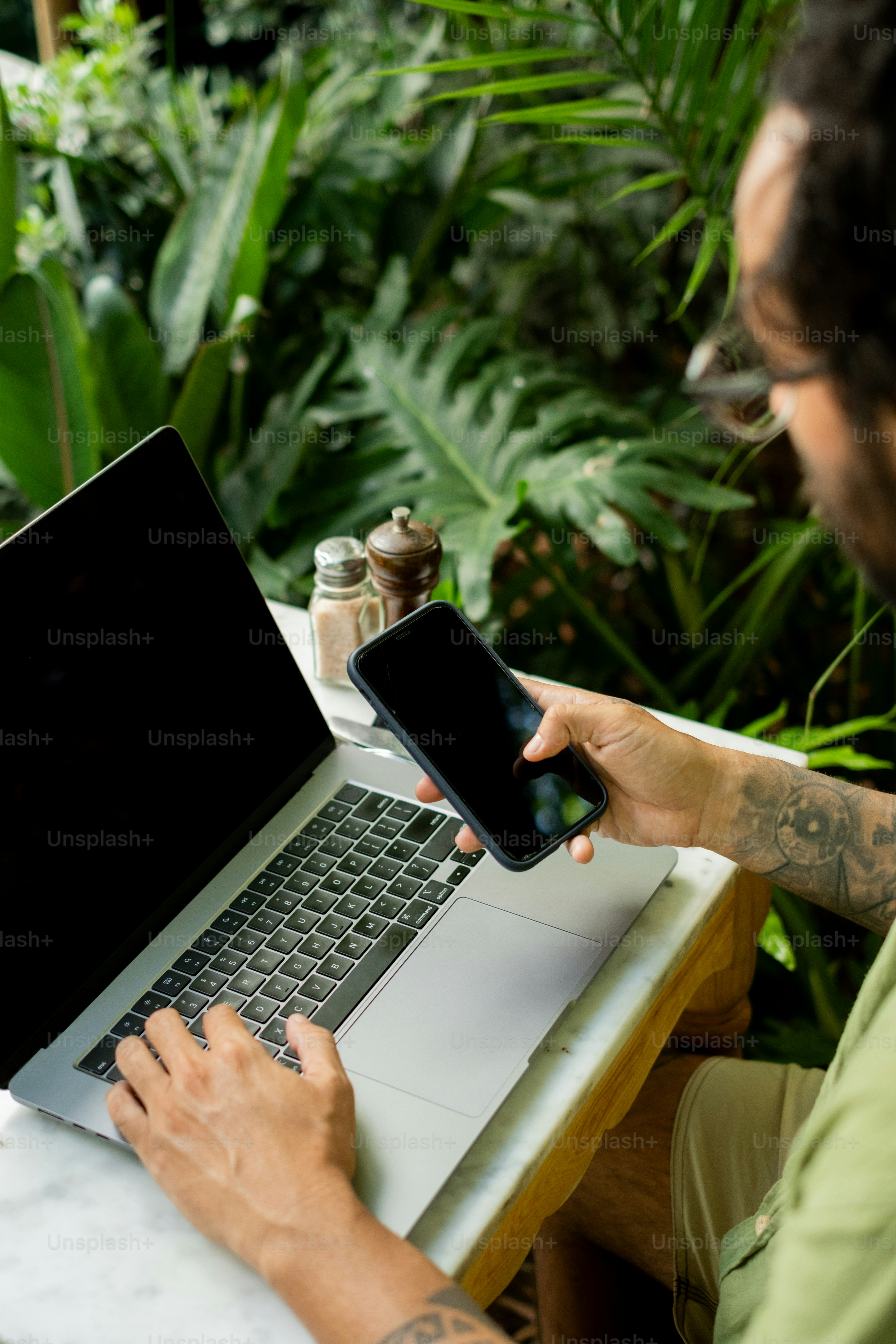 A man sitting in front of a laptop computer