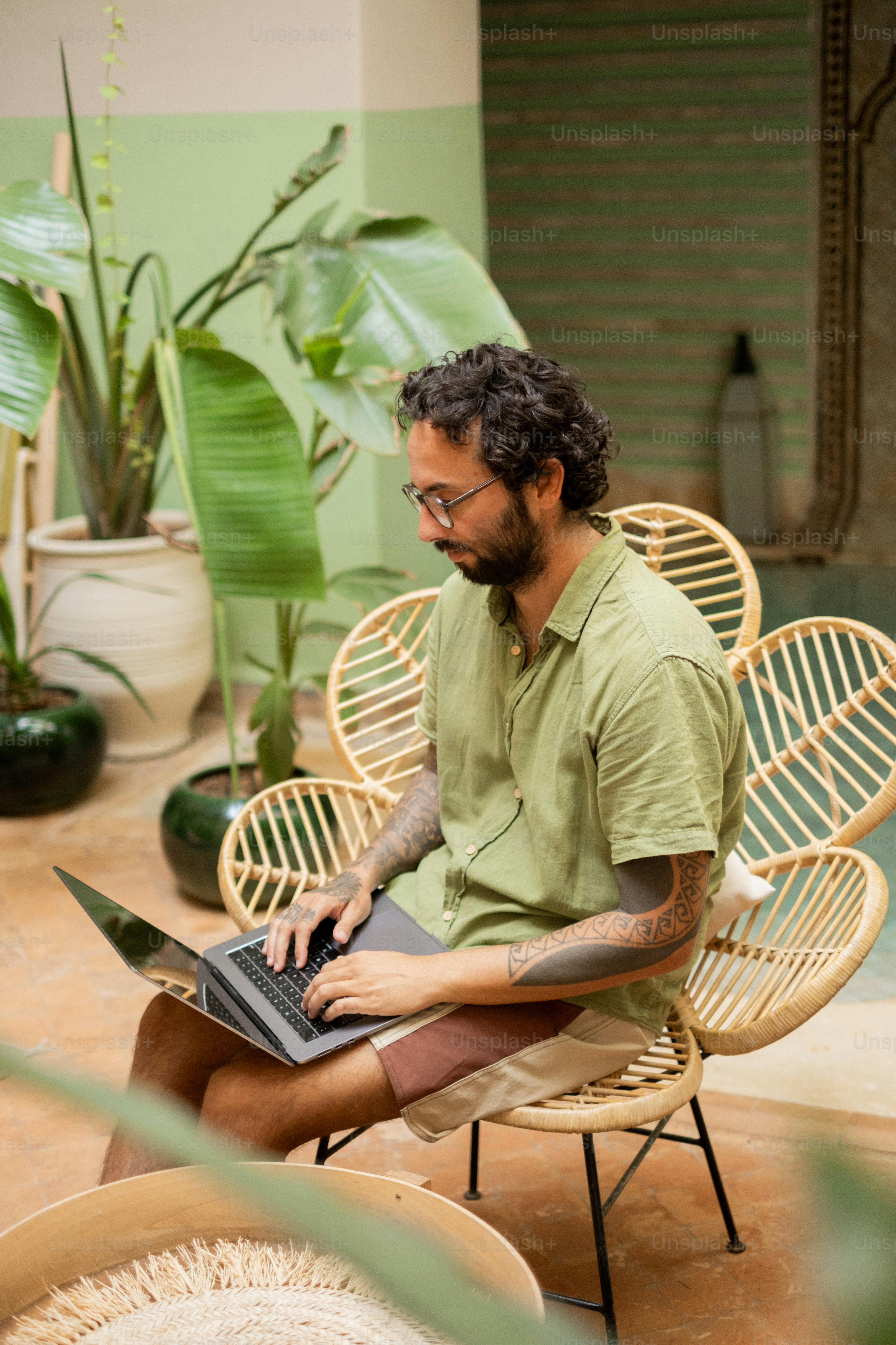 A man sitting in a chair with a laptop