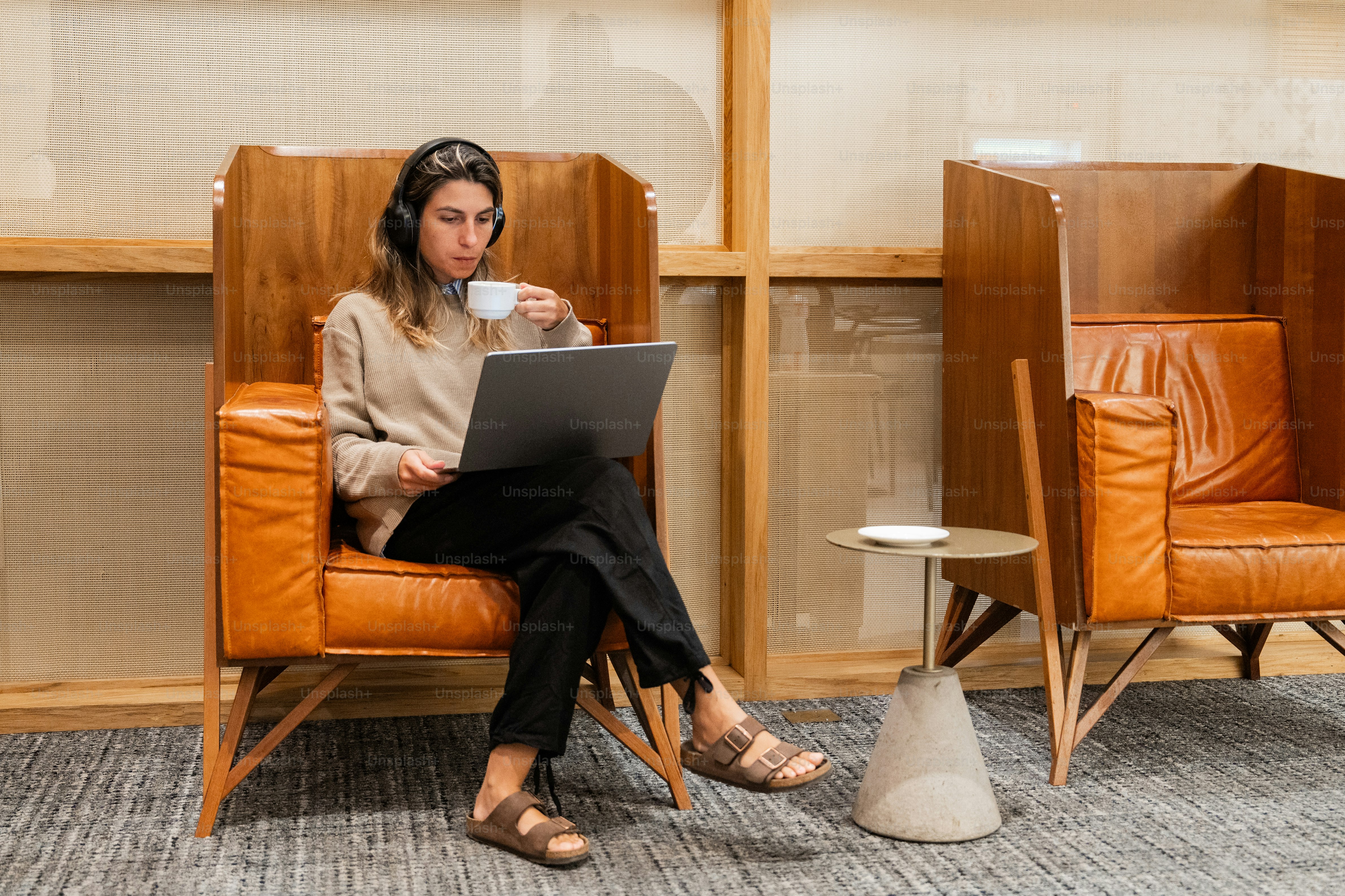 A woman sitting in a chair with a laptop