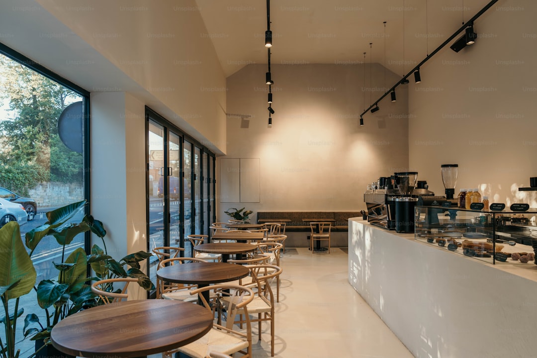 A restaurant with tables and chairs and a large window