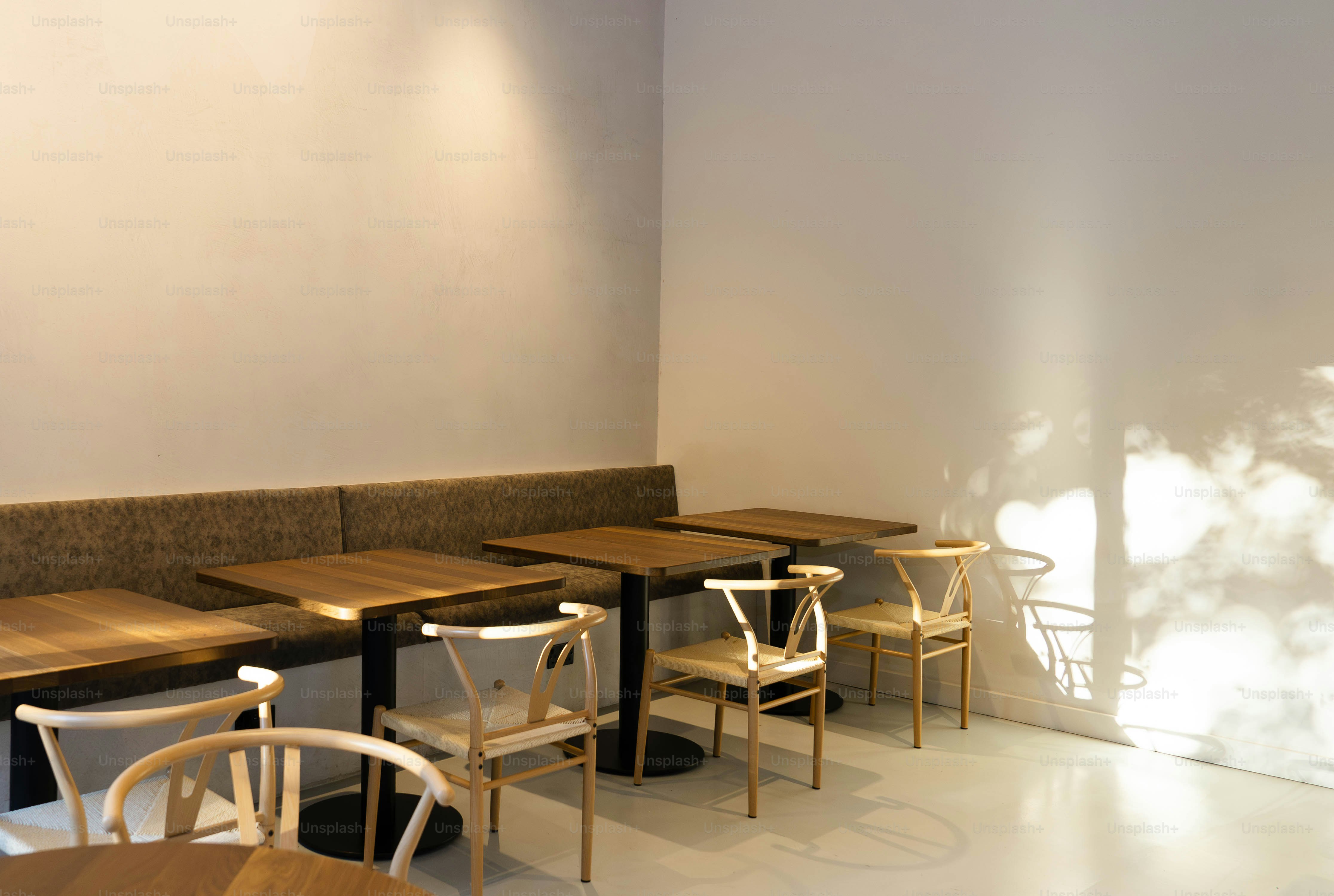 A room with a lot of wooden tables and chairs