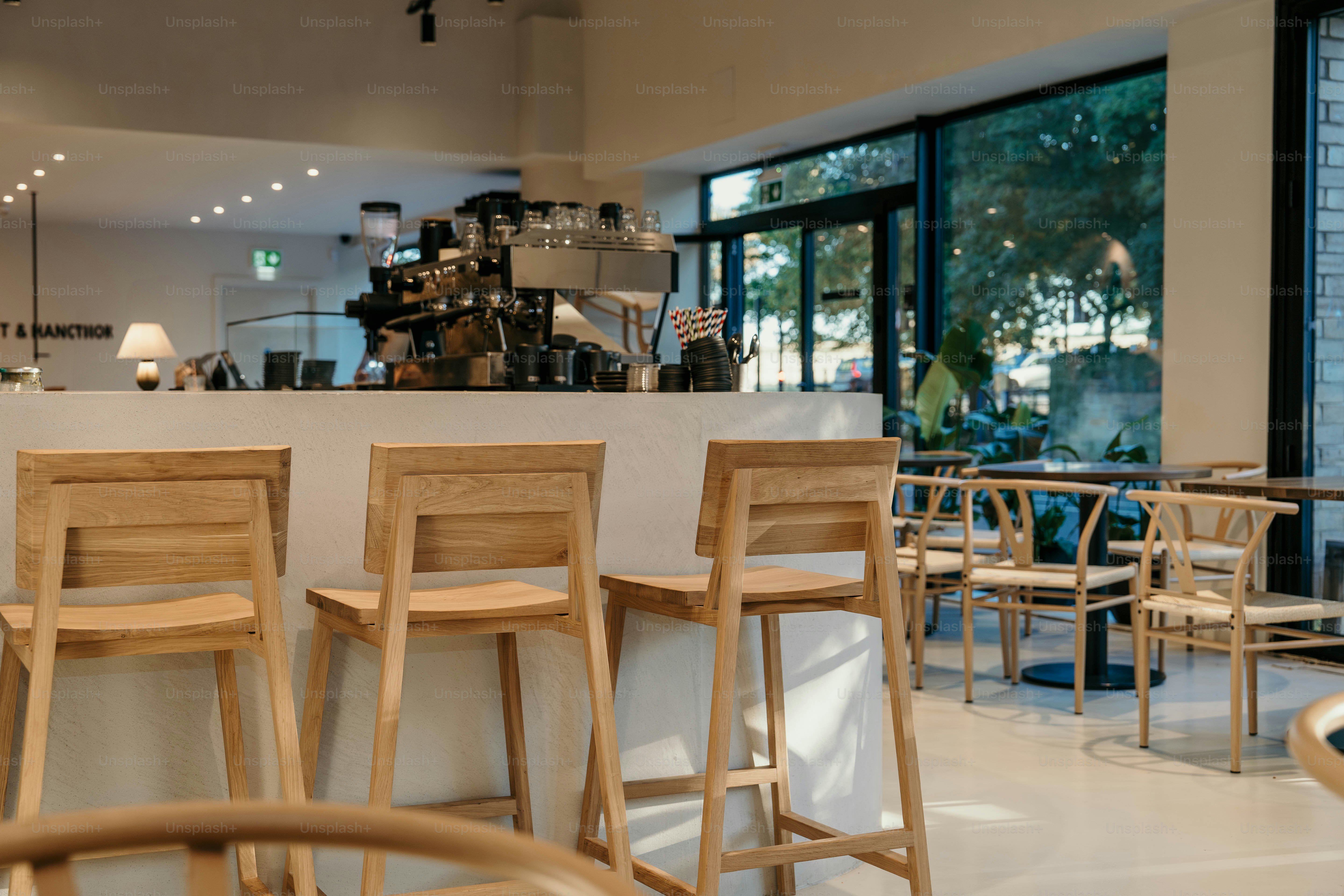 A row of wooden chairs sitting in front of a counter