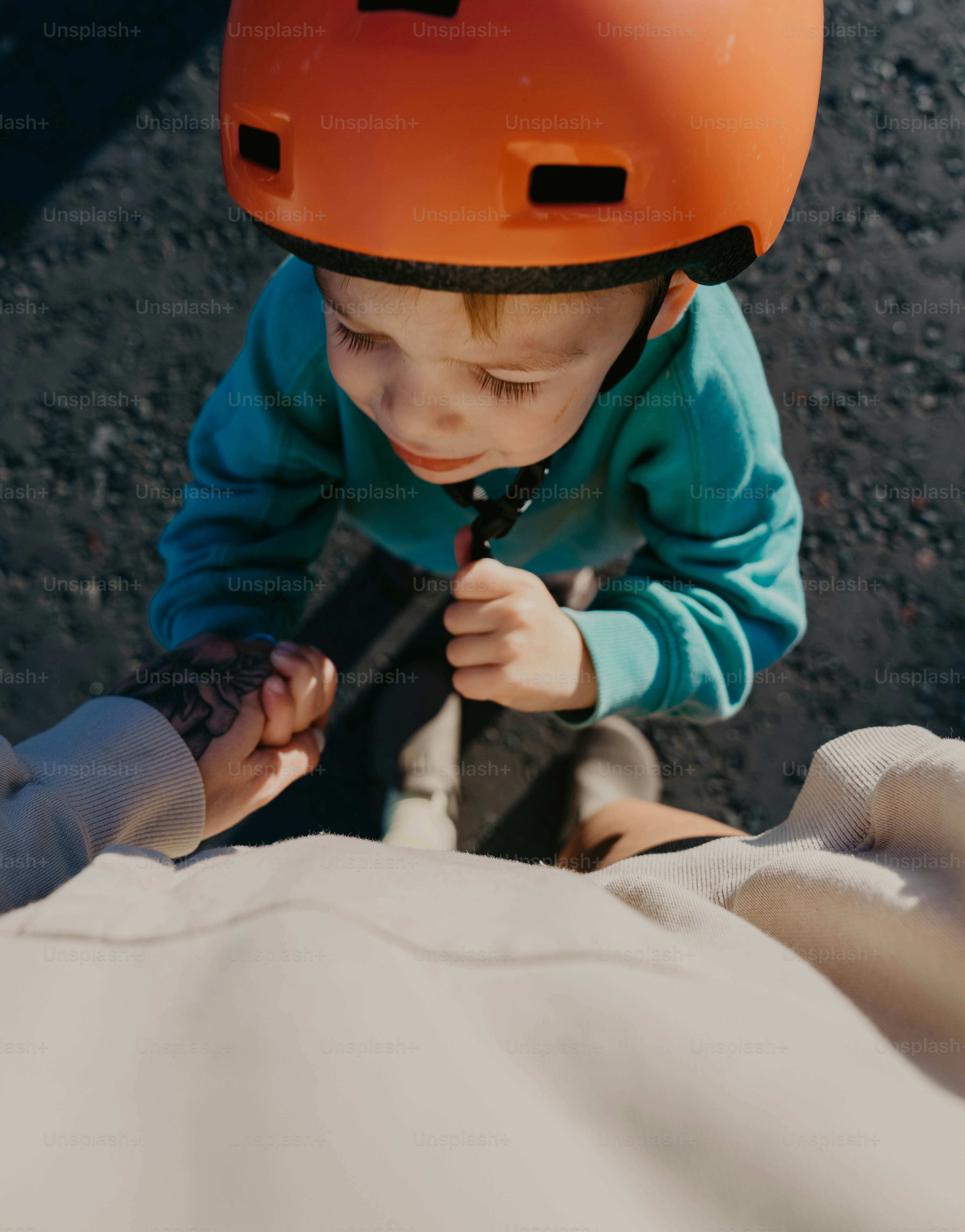 A young child wearing a helmet and holding a baseball bat
