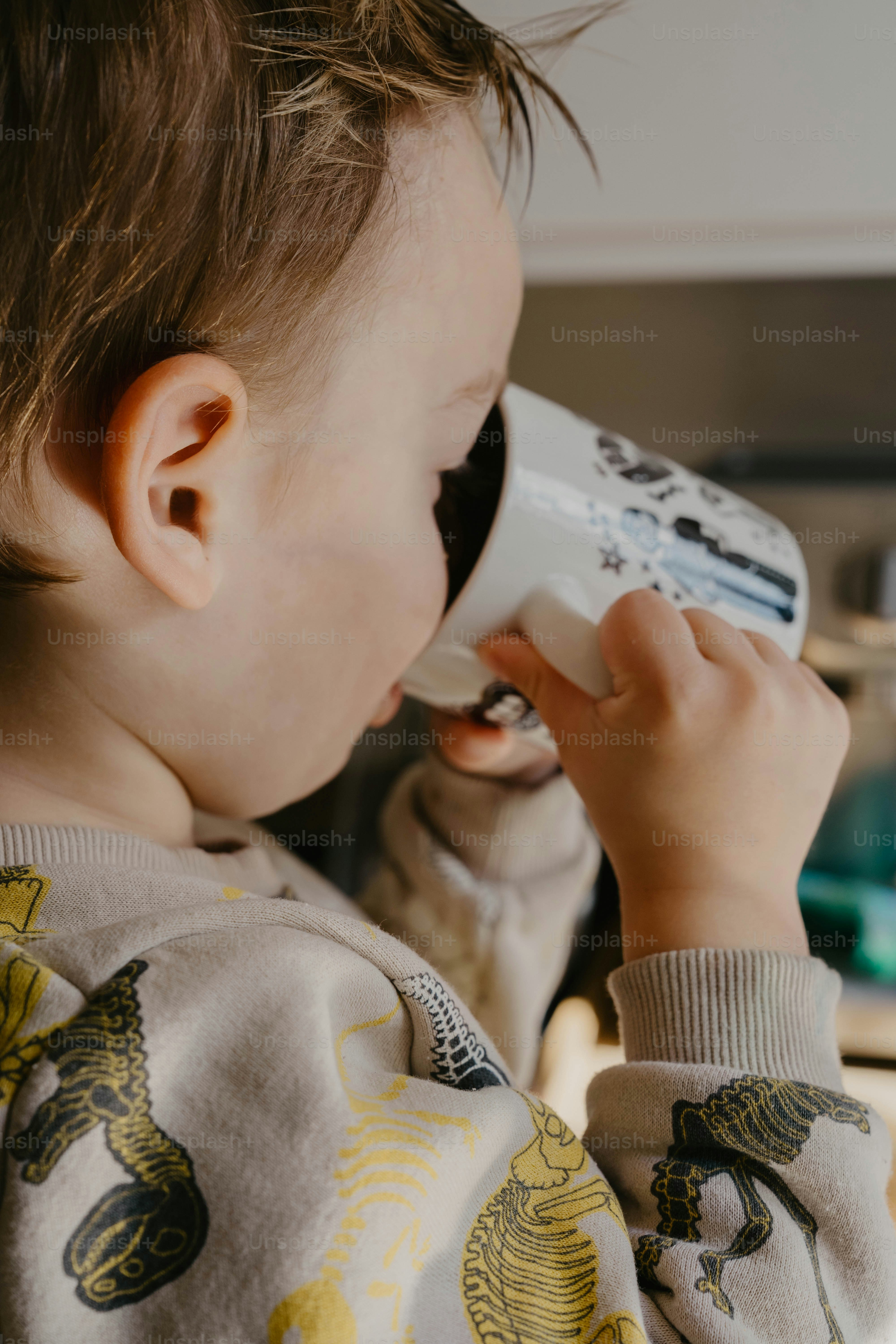 A little boy holding a phone to his ear
