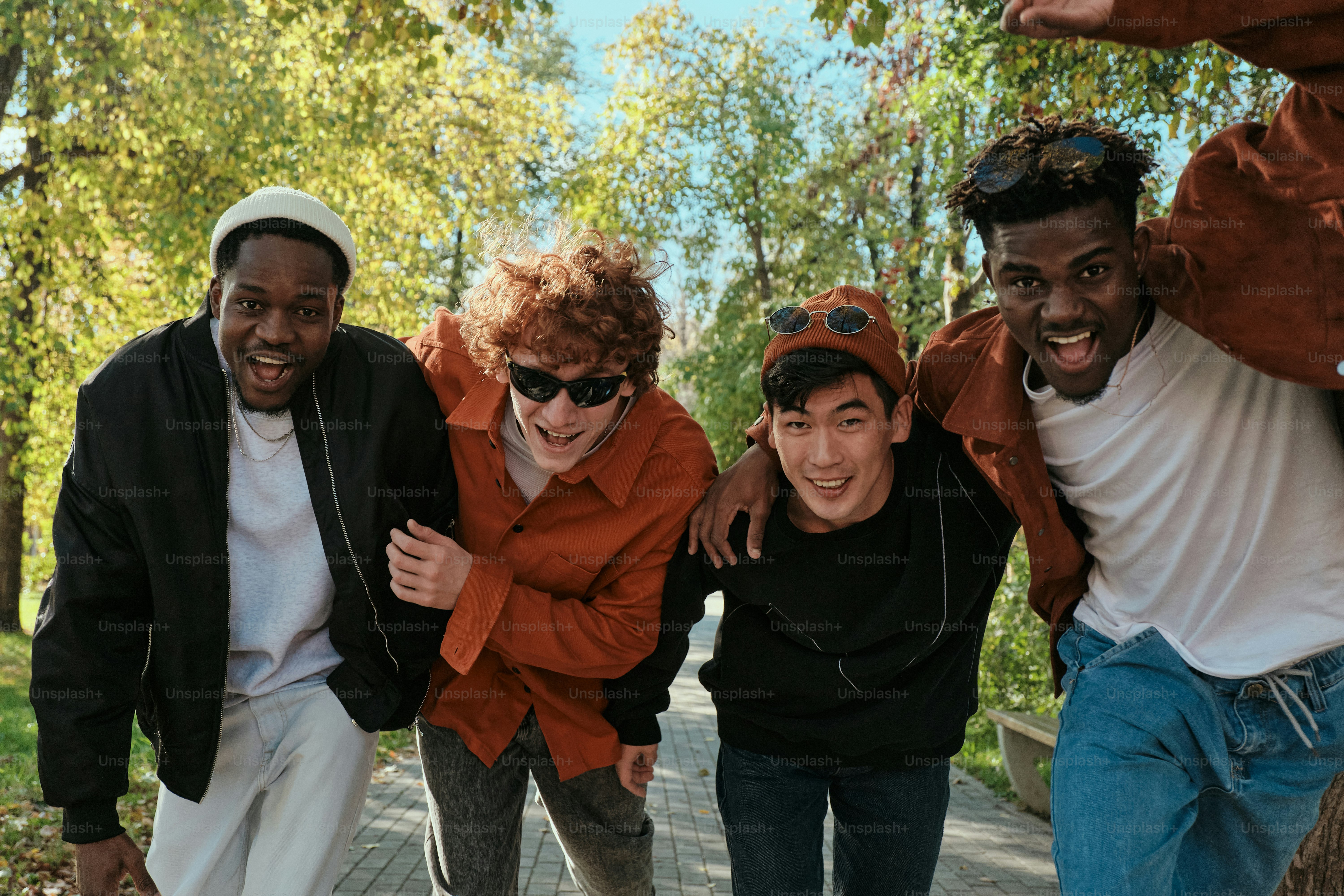 A group of young men standing next to each other photo – Multinational ...