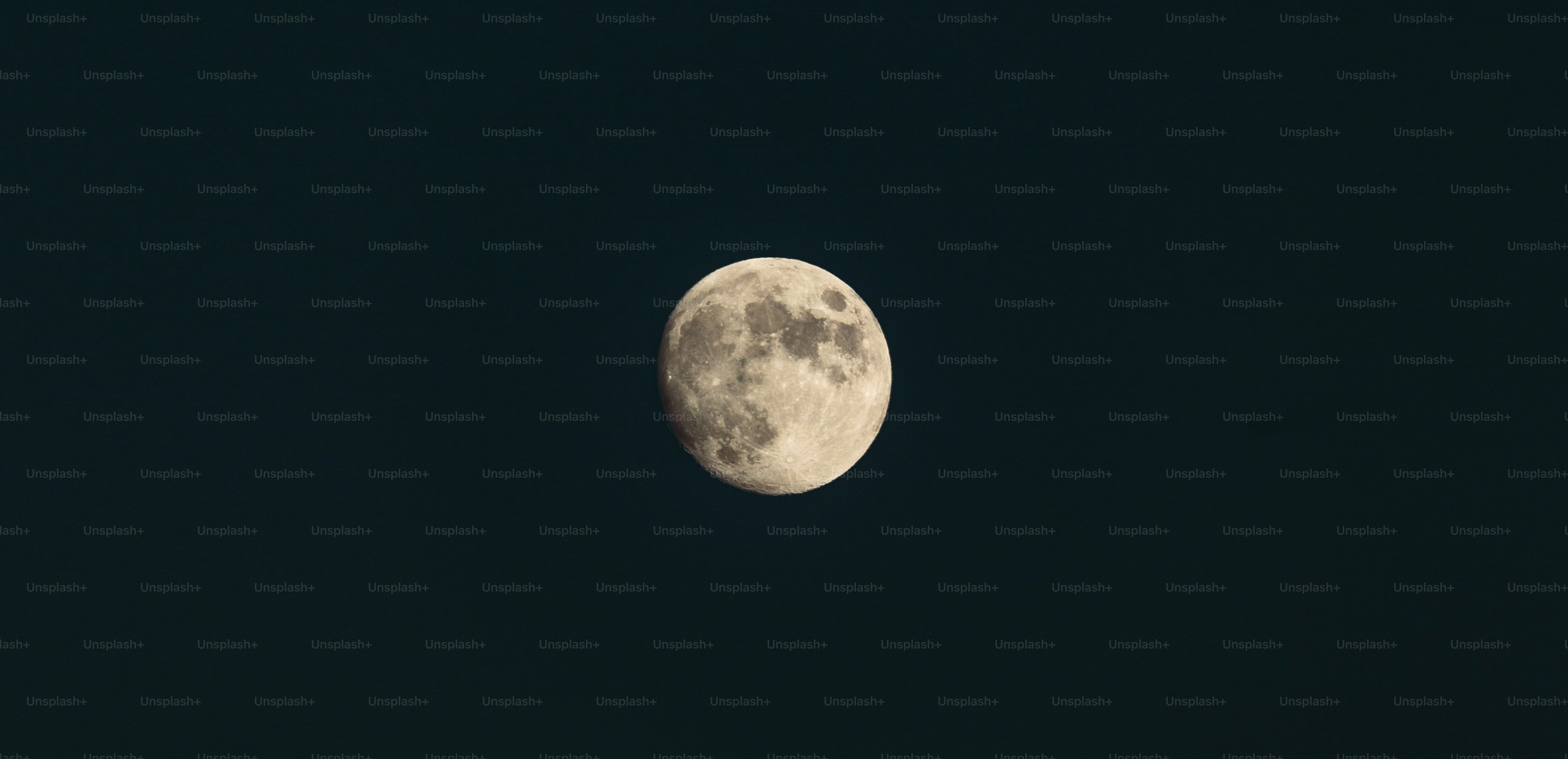 A full moon is seen in the night sky