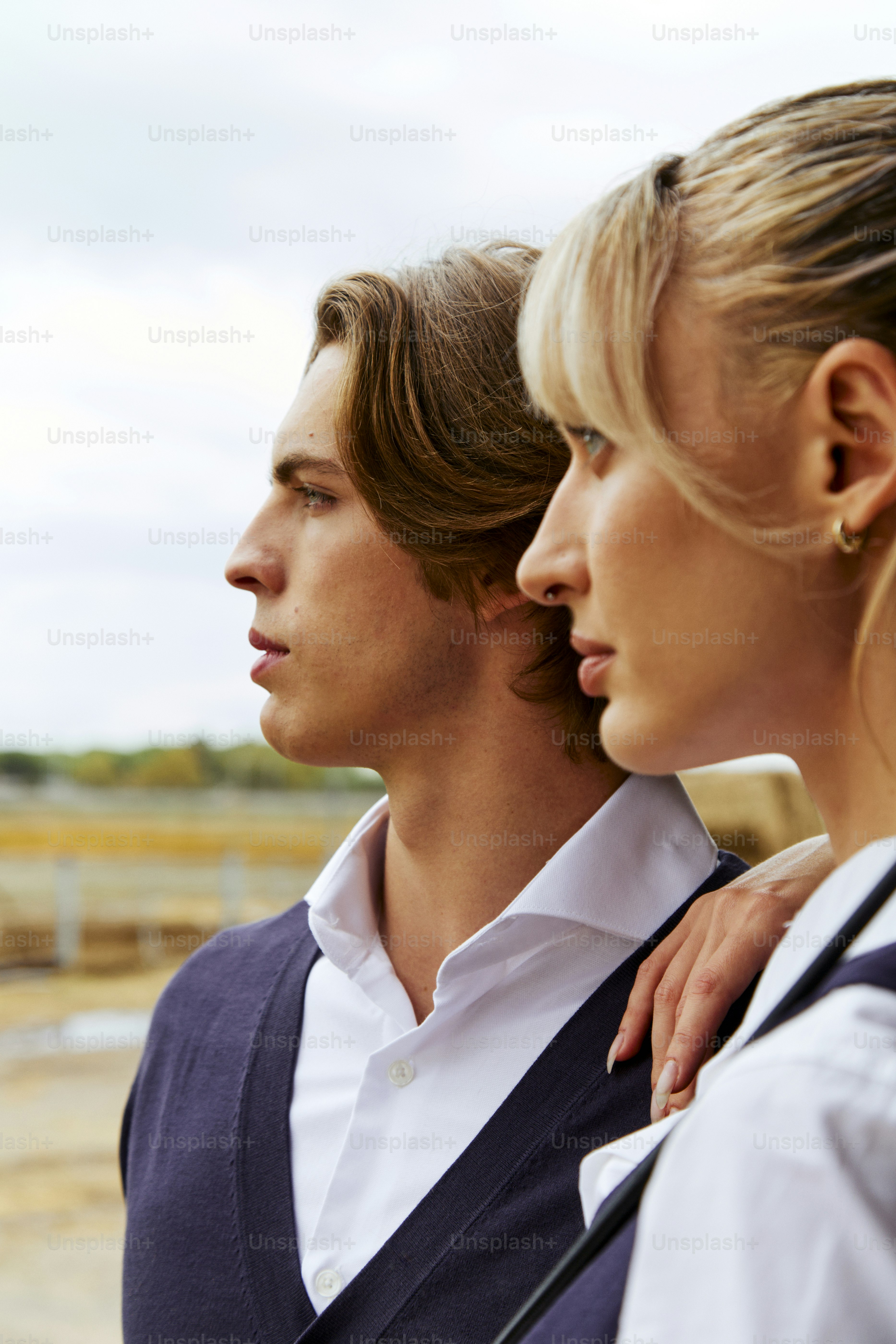 A man and a woman standing next to each other photo – Wealthy Image on ...