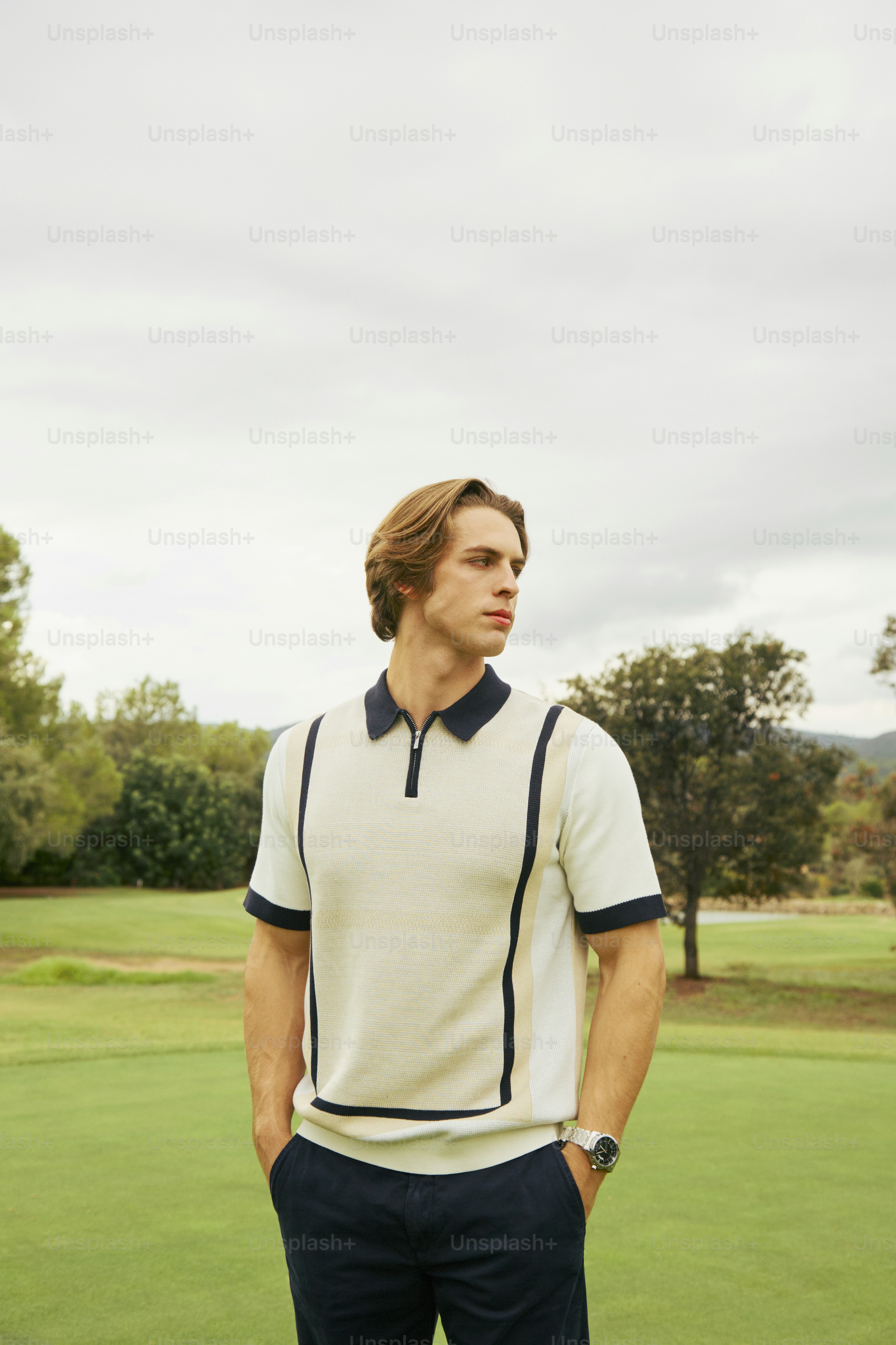 A man standing on top of a lush green field