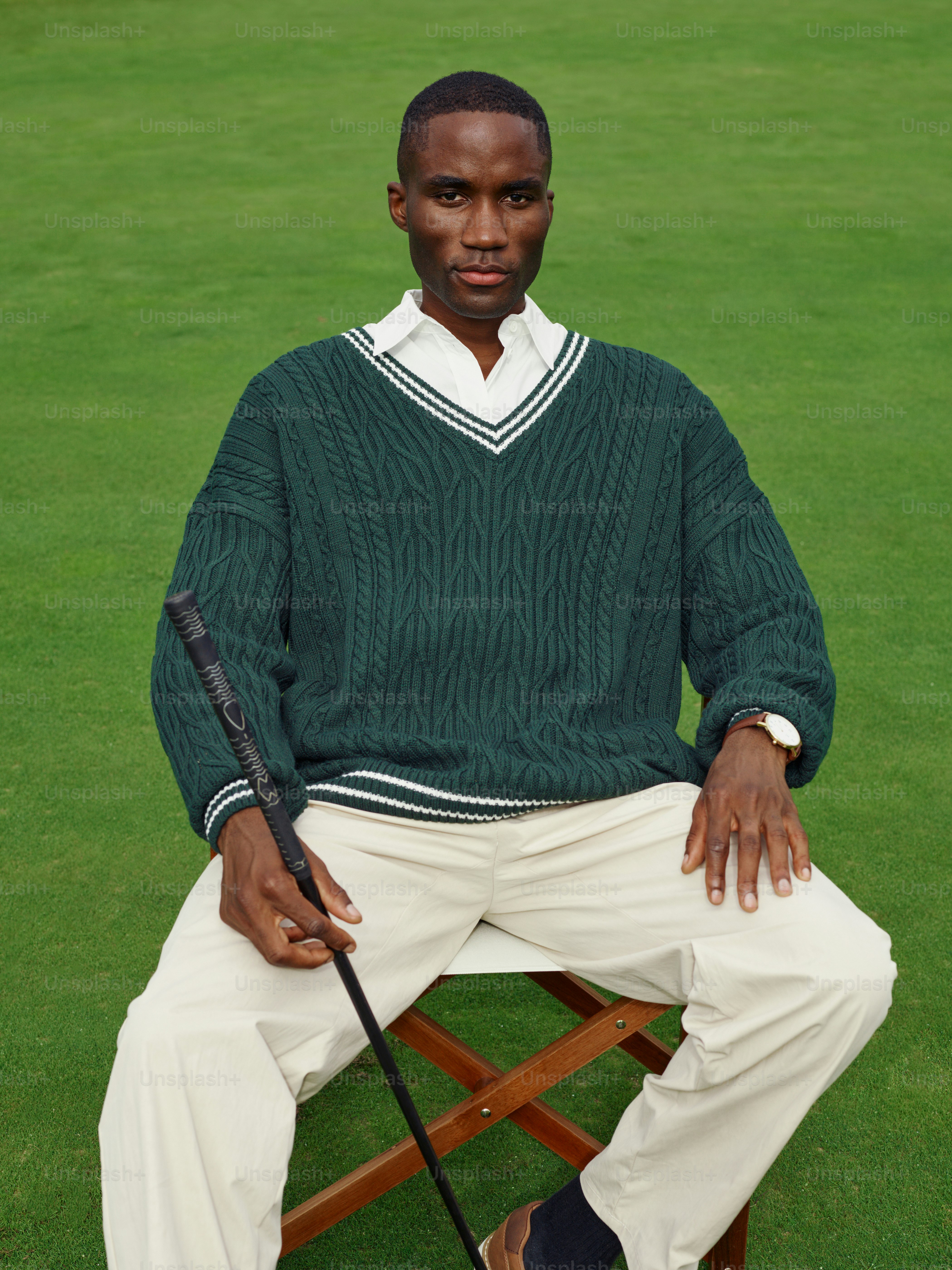 A man sitting on a chair with a baseball bat