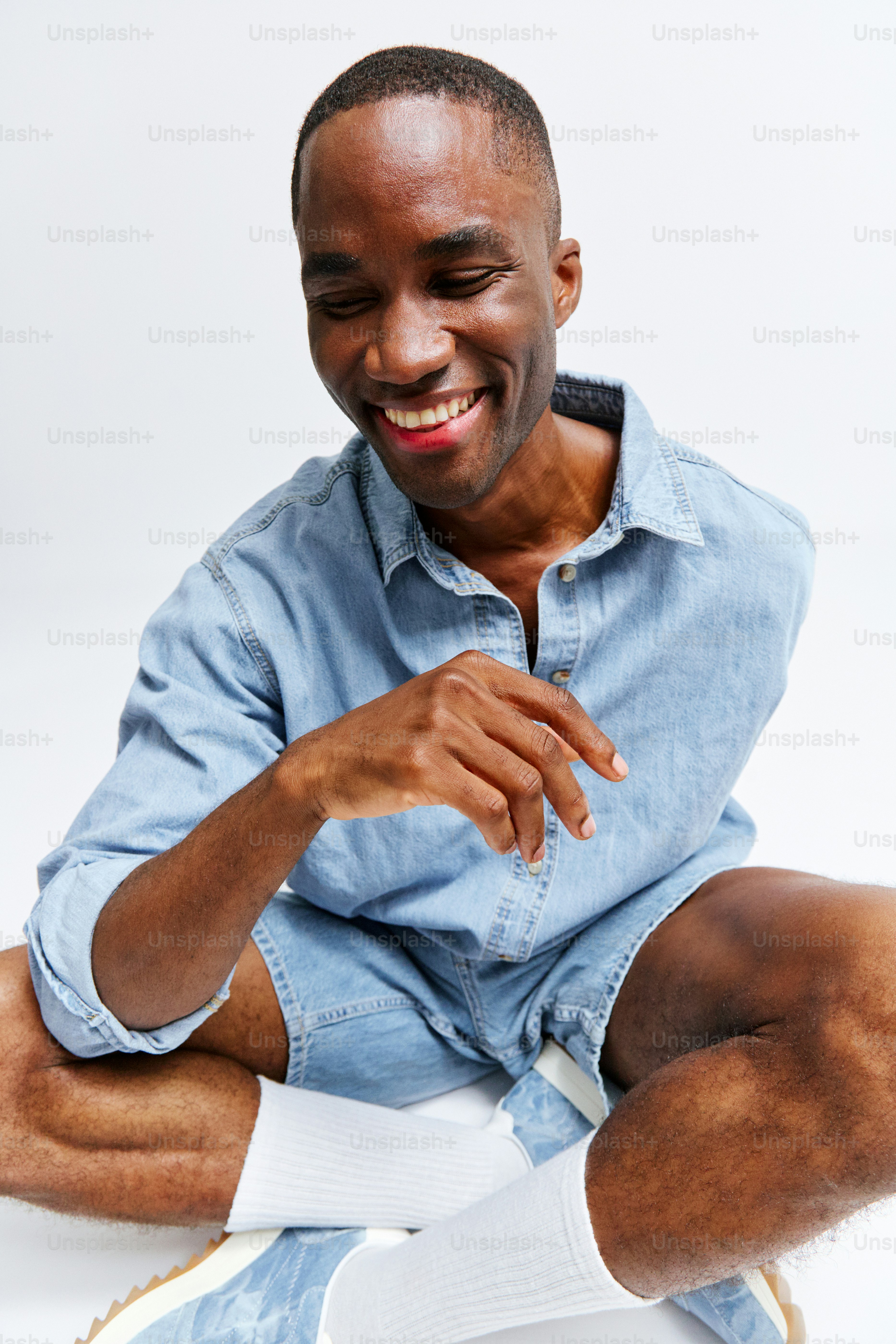 A man in a blue shirt and white socks