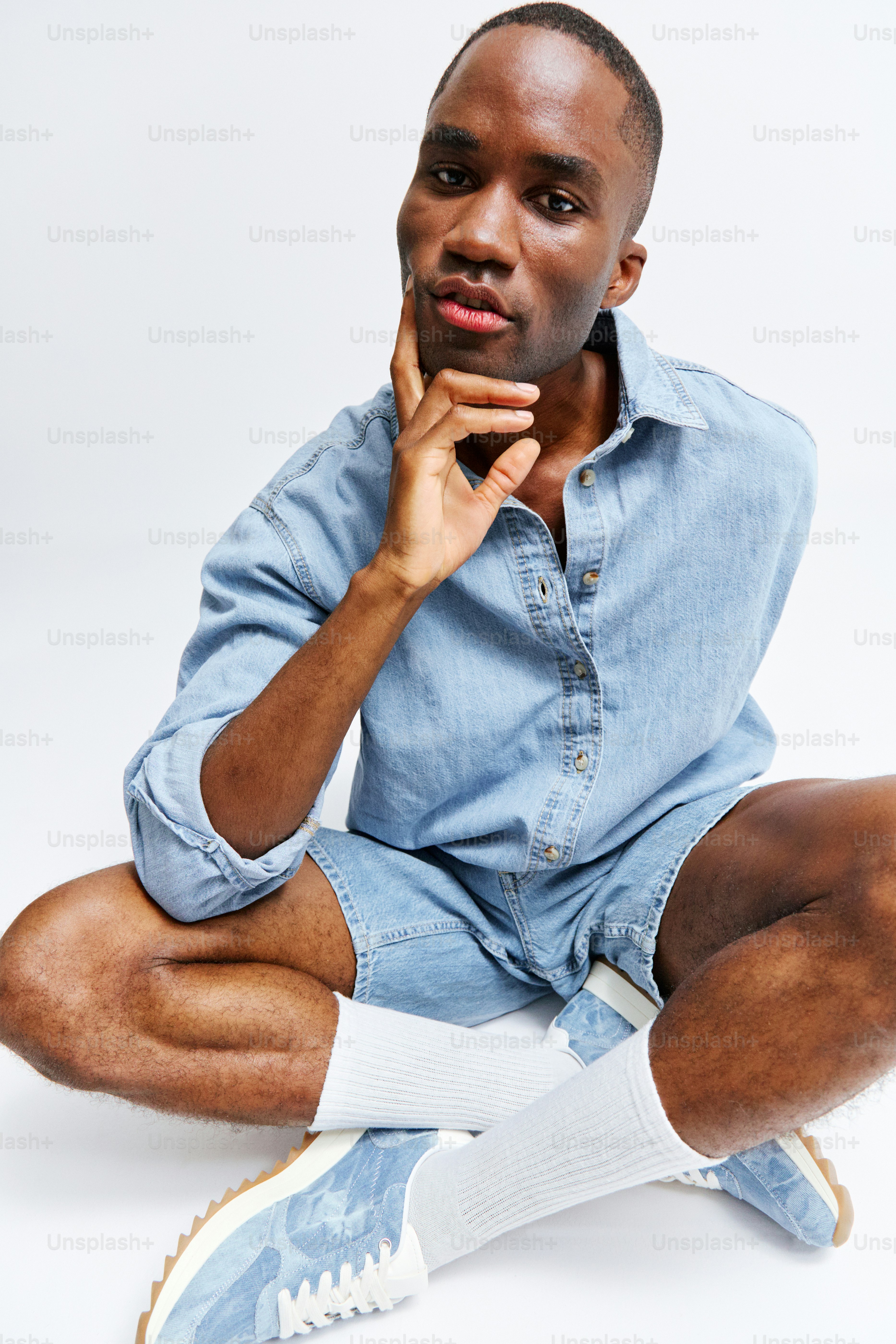 A man sitting on the ground with his legs crossed