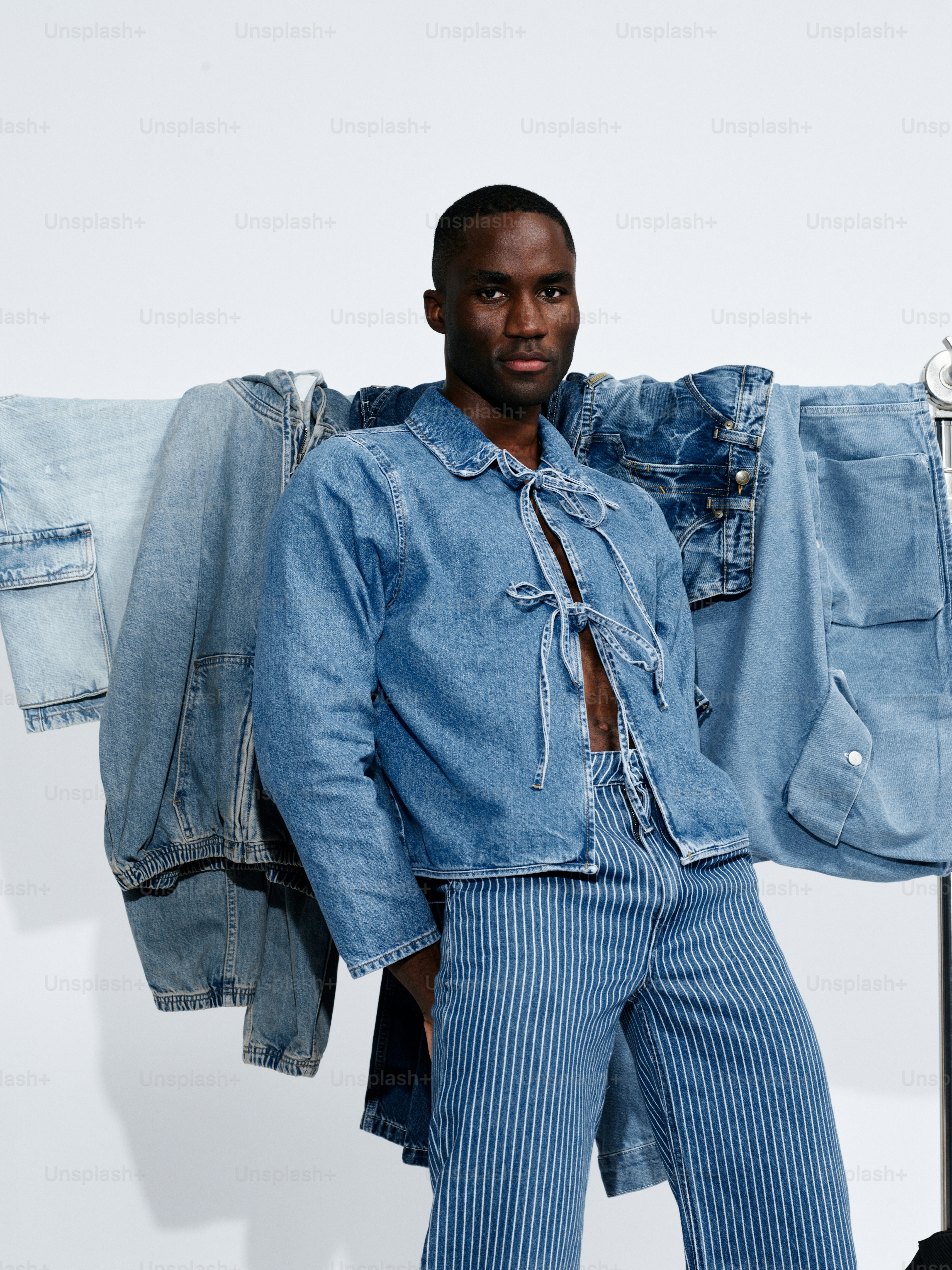A man standing in front of a rack of jeans