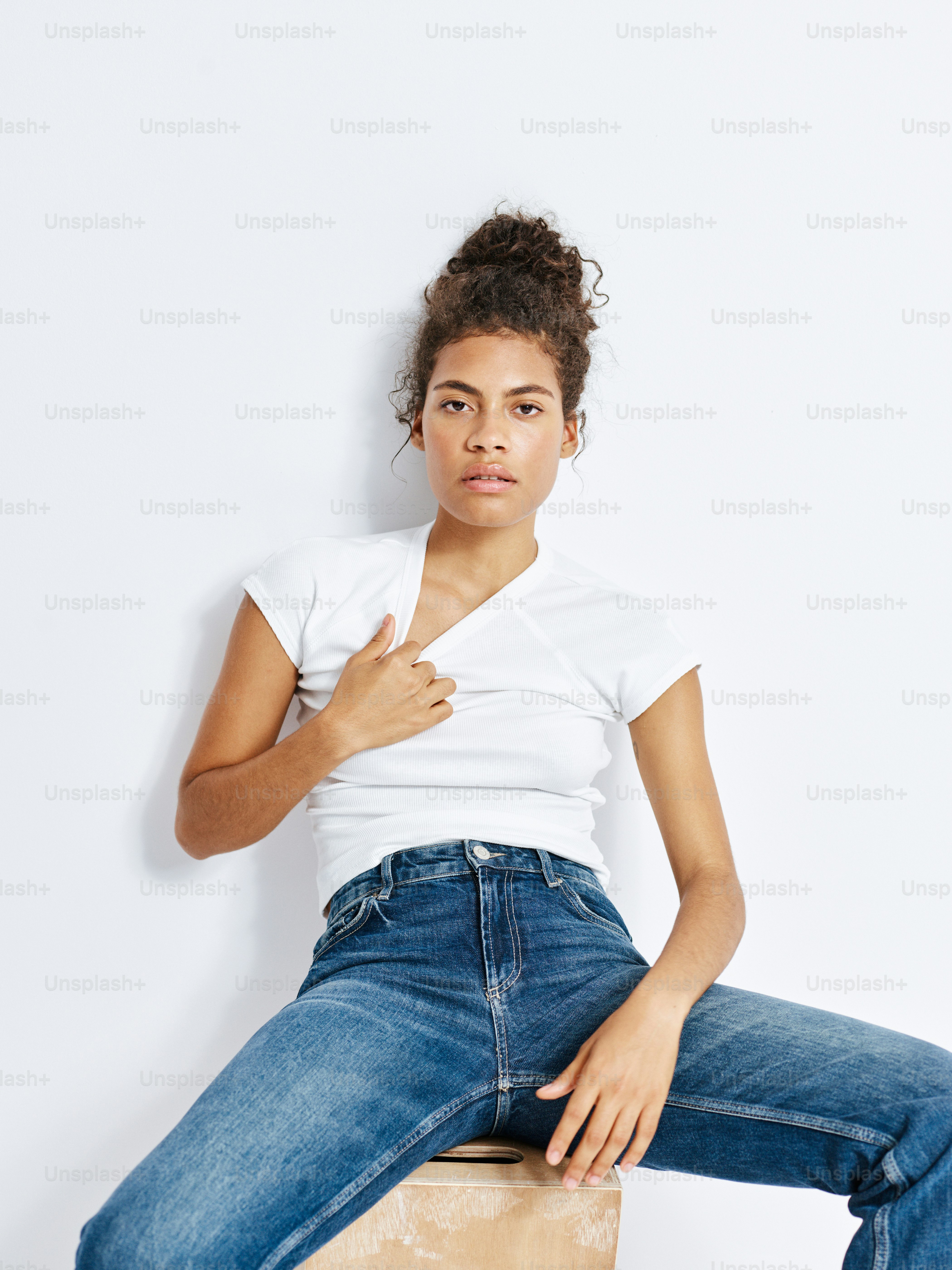 A woman sitting on top of a wooden block