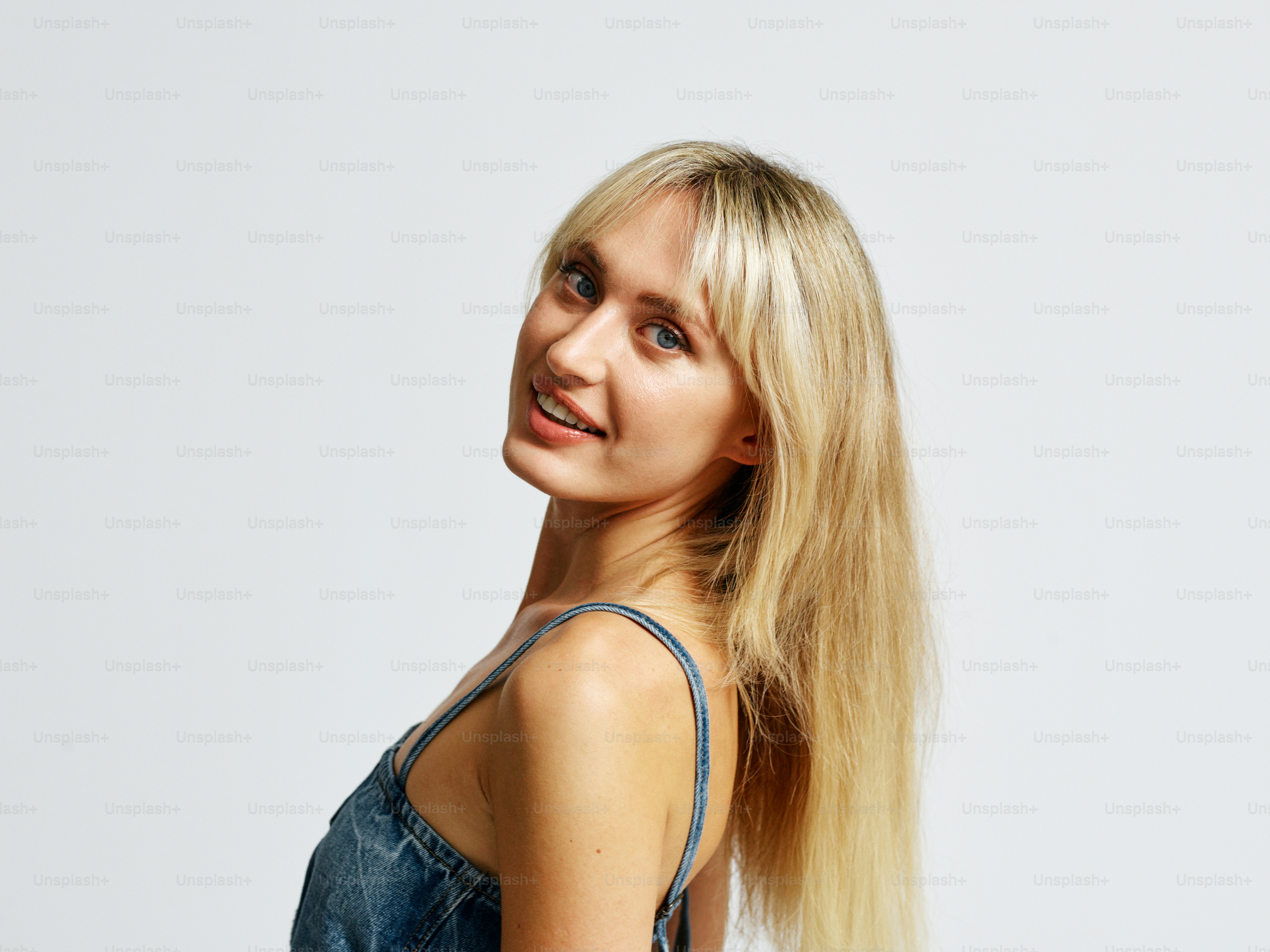 A woman with long blonde hair posing for a picture