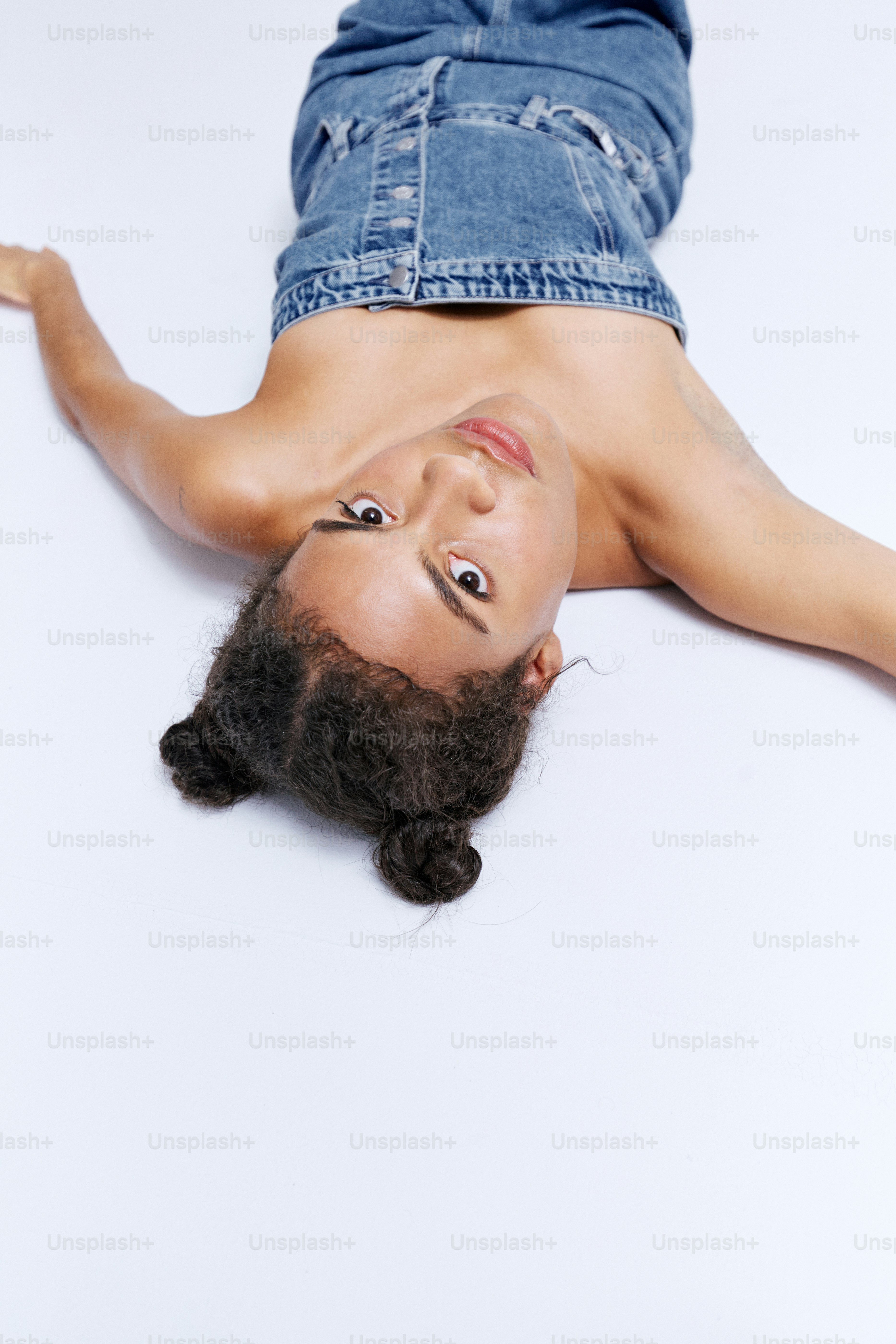 A woman laying on top of a white floor
